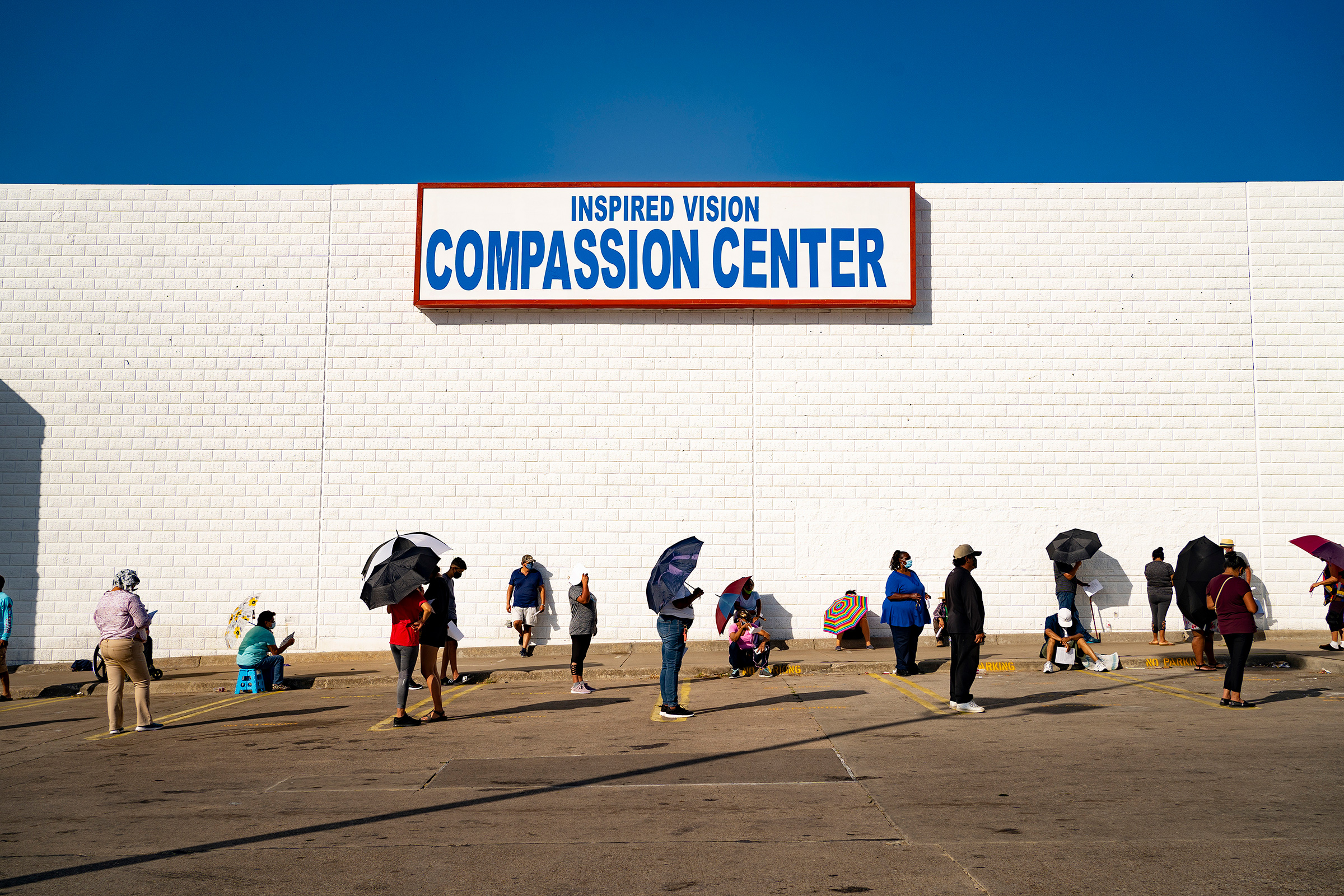 People line up at the Inspired Vision &amp; Compassion Center food bank in Dallas on Aug. 14 (Nitashia Johnson—The New York Times/Redux)
