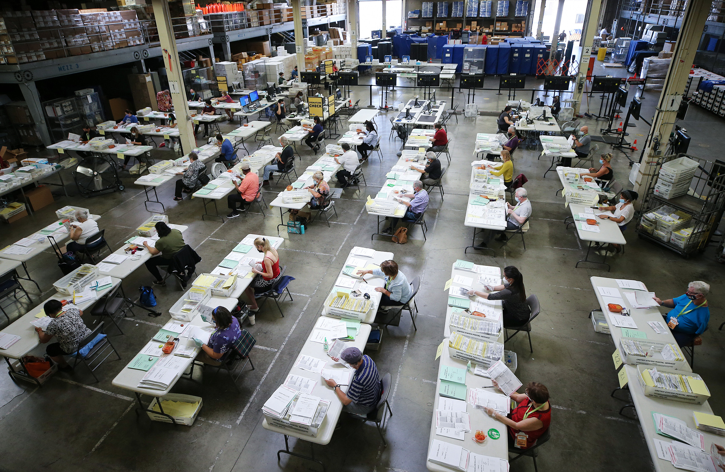 Election workers process mail-in ballots at the Orange County Registrar of Voters in Santa Ana, Calif., on Oct. 19, 2020. (Mario Tama—Getty Images)