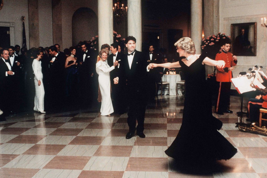 Diana, Princess Of Wales dancing with John Travolta at the White House, Washington, on Nov. 9, 1985. The princess wore a midnight blue velvet dress by fashion designer Victor Edelstein, as President Ronald and Mrs Nancy Reagan watched on (Tim Graham Photo Library via Getty Images)