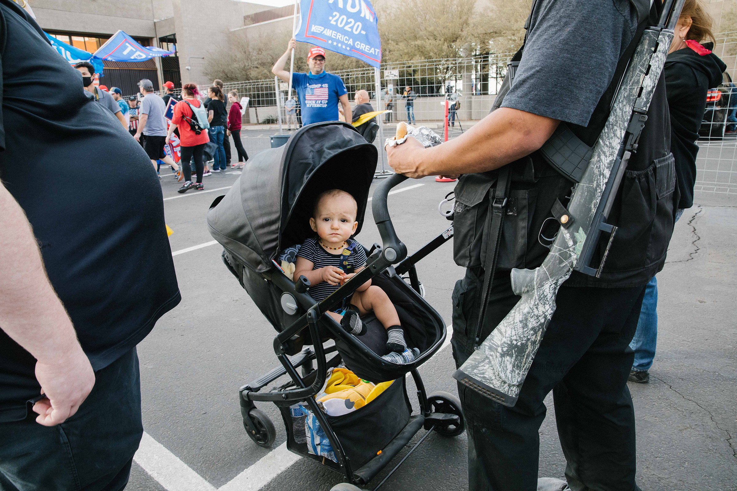 A baby and a gun at the Maricopa County Elections office in Phoenix, AZ on November 7, 2020