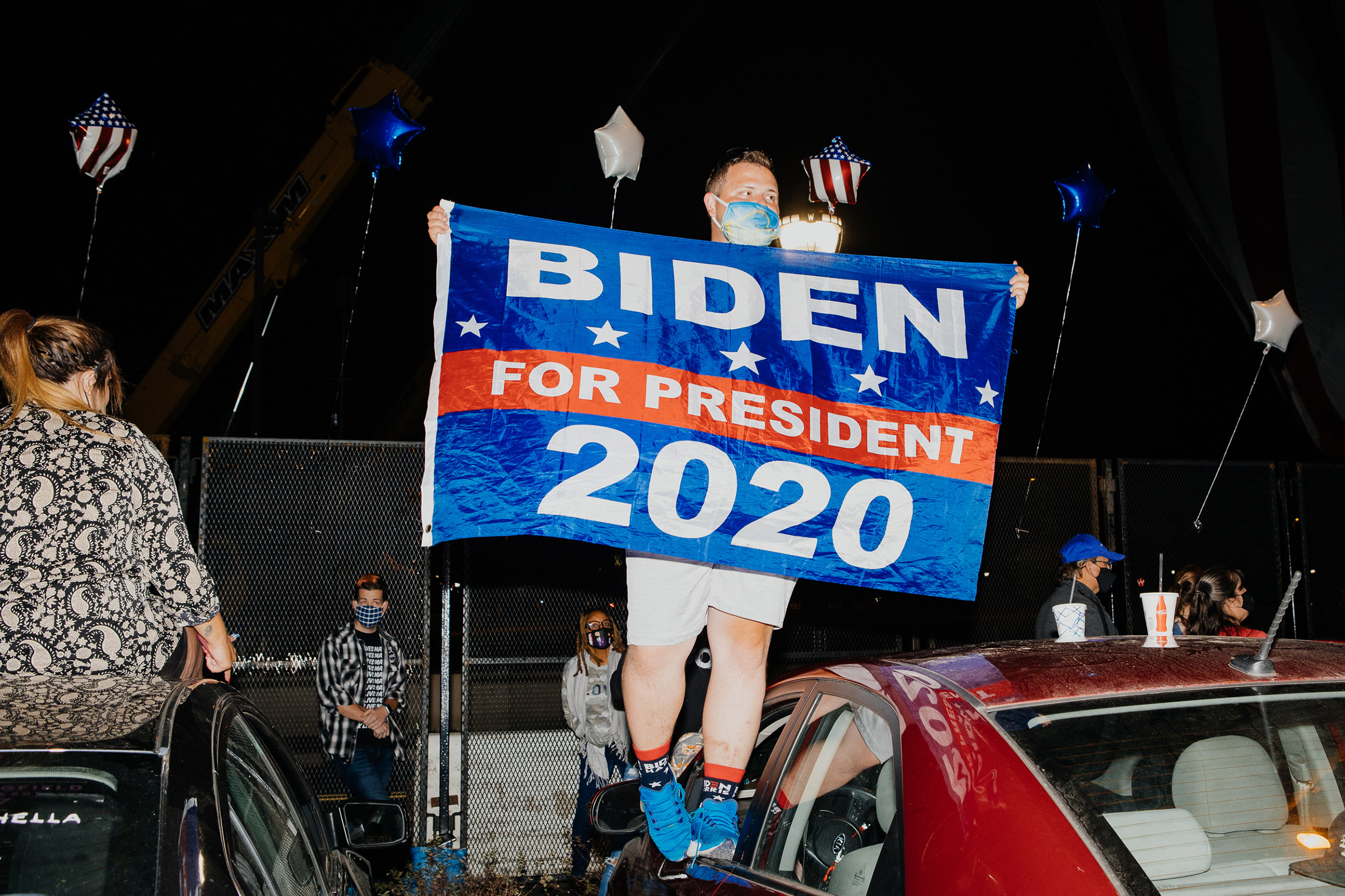 Zach Rossetti, 25, holds a Biden flag on top of his car outside the Chase Center in Wilmington, Delaware on Saturday, November 7, 2020. Rossetti traveled from Scranton, Pennsylvania, the President-Elect’s hometown, to witness Biden’s Speech. “It’s not every day that the President-Elect is from your hometown,” he said. (Michelle Gustafson for Time)