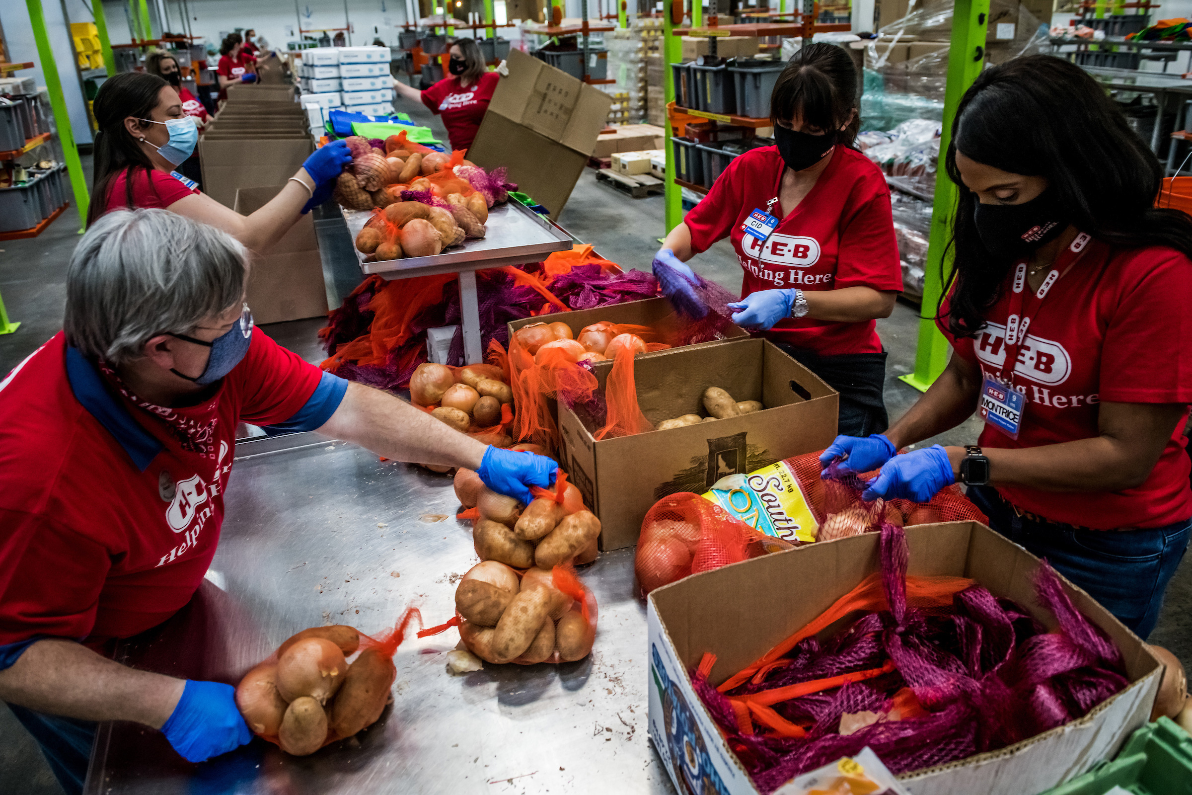 The Houston Food Bank and Texas-based grocery chain H-E-B combine their resources to orchestrate a massive food-distribution event. H-E-B employees, pictured Nov. 17, are packaging boxes full of Thanksgiving necessities in preparation for high demand. (Meridith Kohut for TIME)
