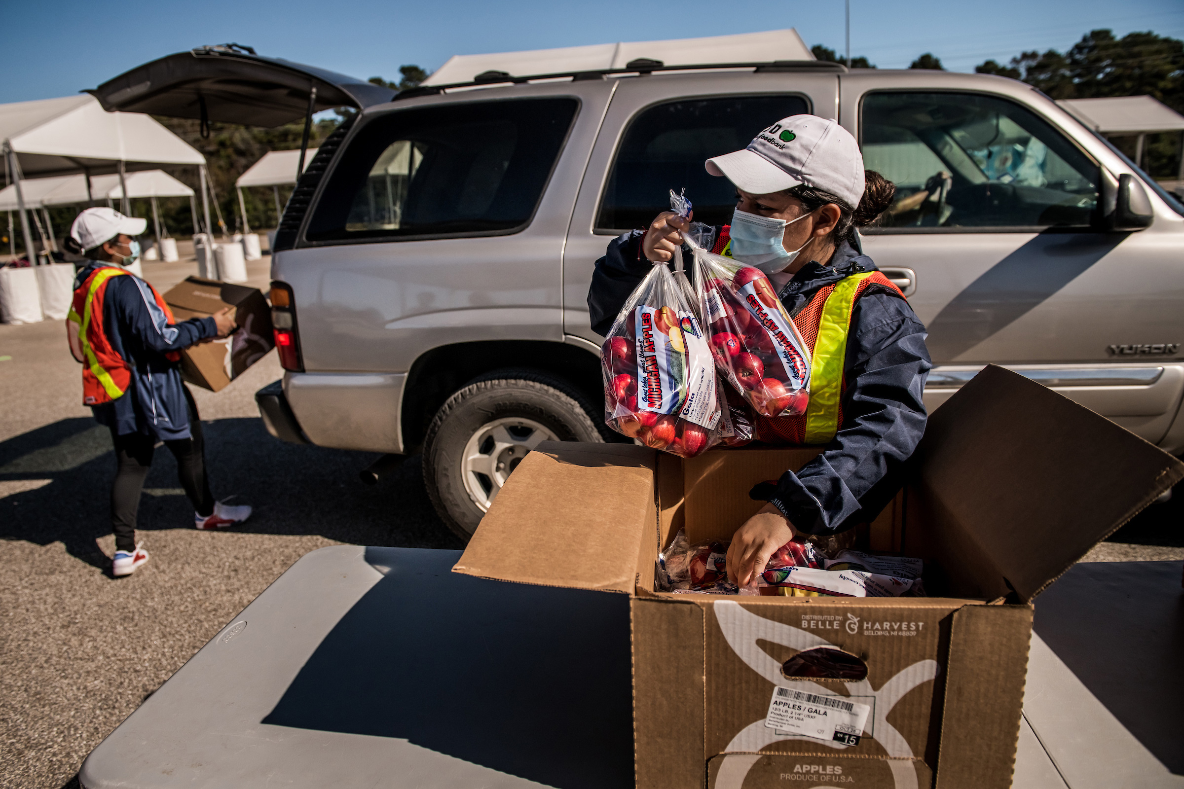 Boxes of food are loaded into cars at the food distribution site run by the Houston Food Bank. (Meridith Kohut for TIME)