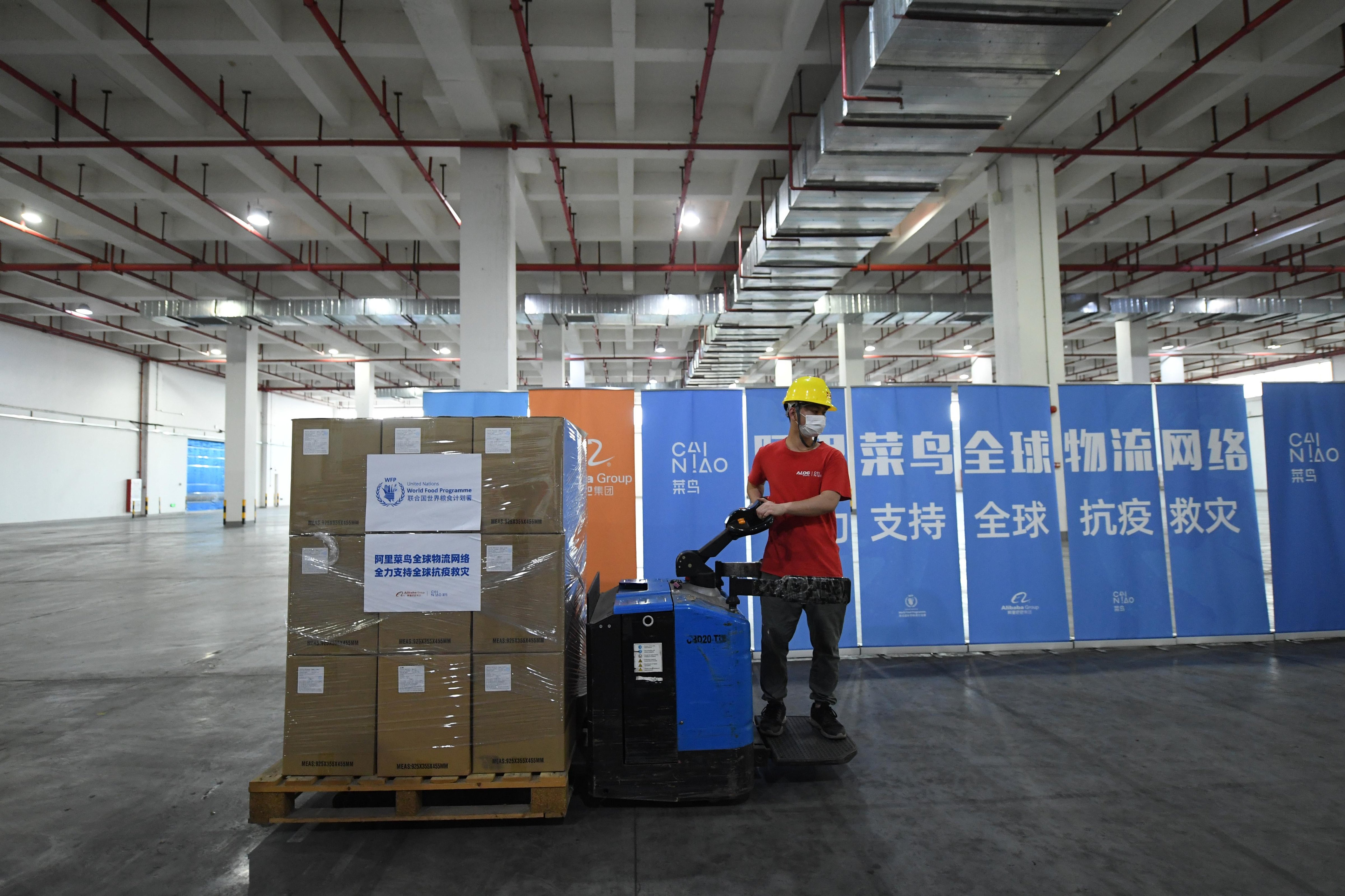 A staff member arranges boxes of anti-epidemic supplies of the United Nations World Food Programme (WFP) at Cainiao's Nansha warehouse on in Guangzhou, China on April 29, 2020. (Ji Dong—China News Service/Getty Images)