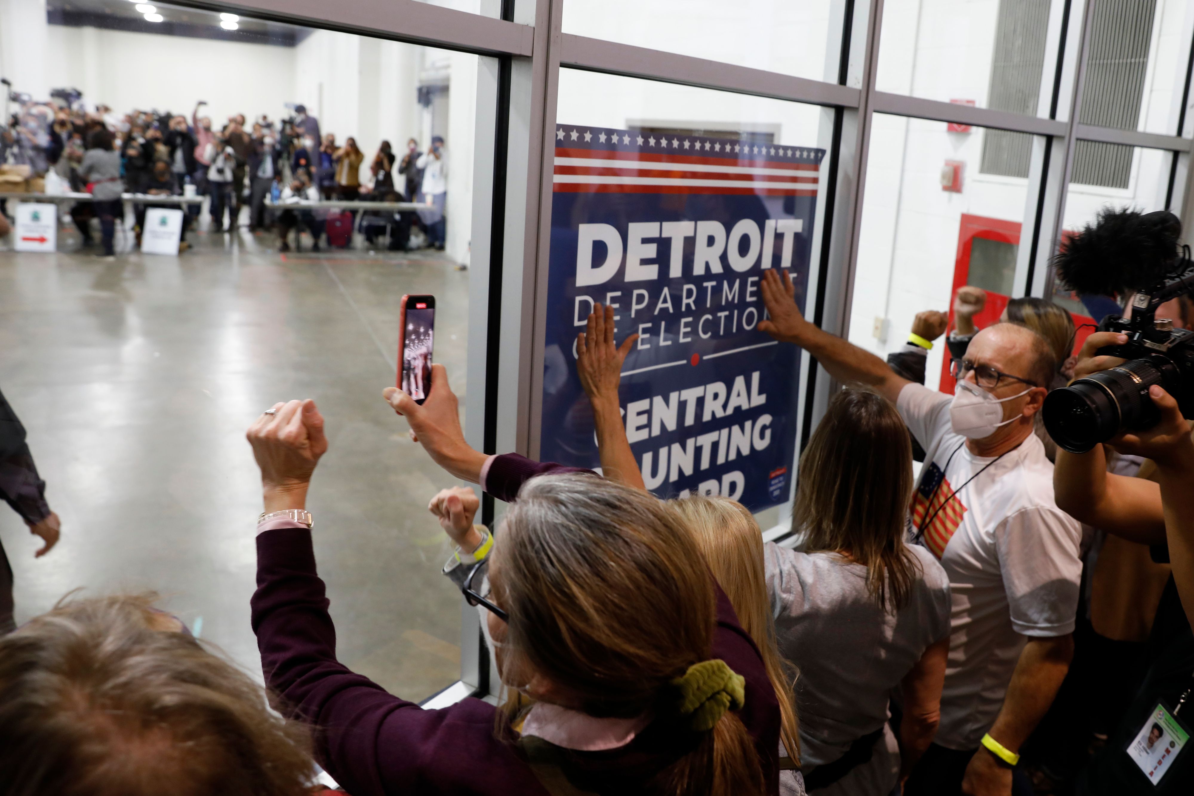 Supporters of  President Donald Trump bang on the glass during a protest outside a room where absentee ballots were being counted at the TCF Center in Detroit on Nov. 4, 2020. (Jeff Kowalsky—AFP/Getty Images)