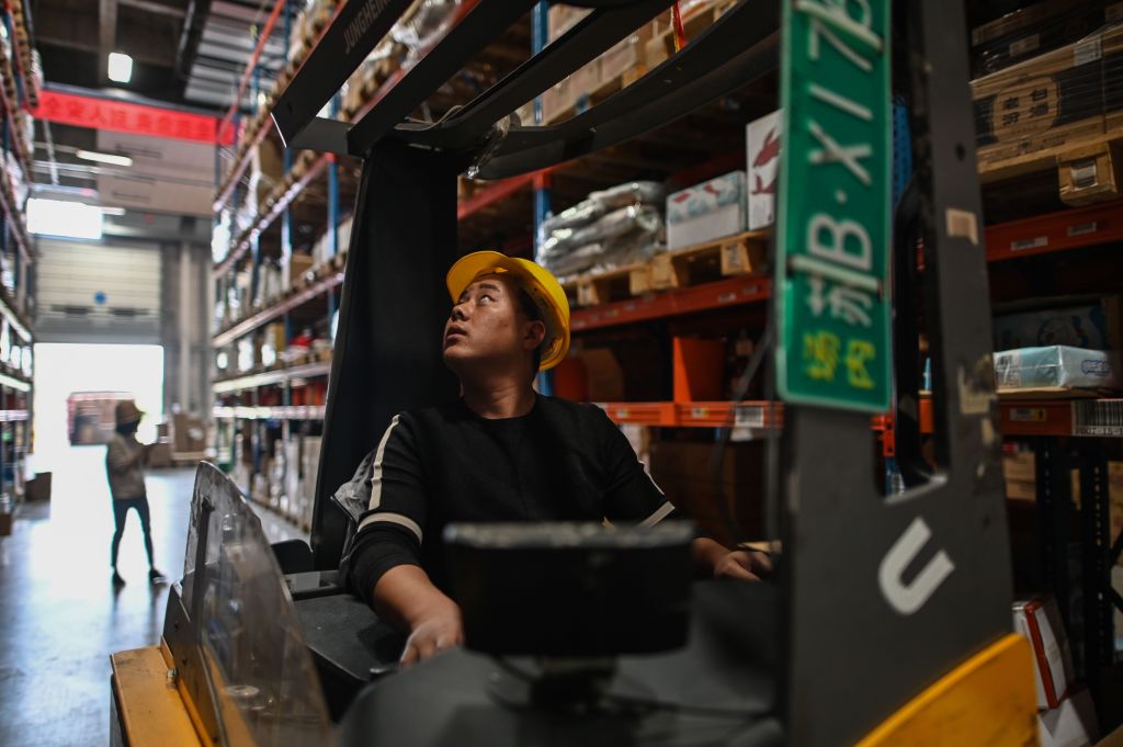 In this picture taken on November 6, 2020, an employee works in the warehouse of Cainiao Smart Logistics Network, the logistics affiliate of e-commerce giant Alibaba, in Wuxi, China's eastern Jiangsu province, ahead of Singles' Day, also known as the Double 11 shopping festival - the world's biggest shopping event - which falls on November 11. (Photo by HECTOR RETAMAL/AFP via Getty Images)