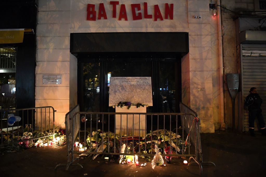 A picture taken on Nov. 13, 2017 shows lightened candles, flowers and messages at a makeshift memorial around the commemorative plaque outside the Bataclan concert hall in tribute of the victims of the attack on the Bataclan in which 90 people were killed on Nov. 13, 2015 (Christophe Archambault—AFP via Getty Images)