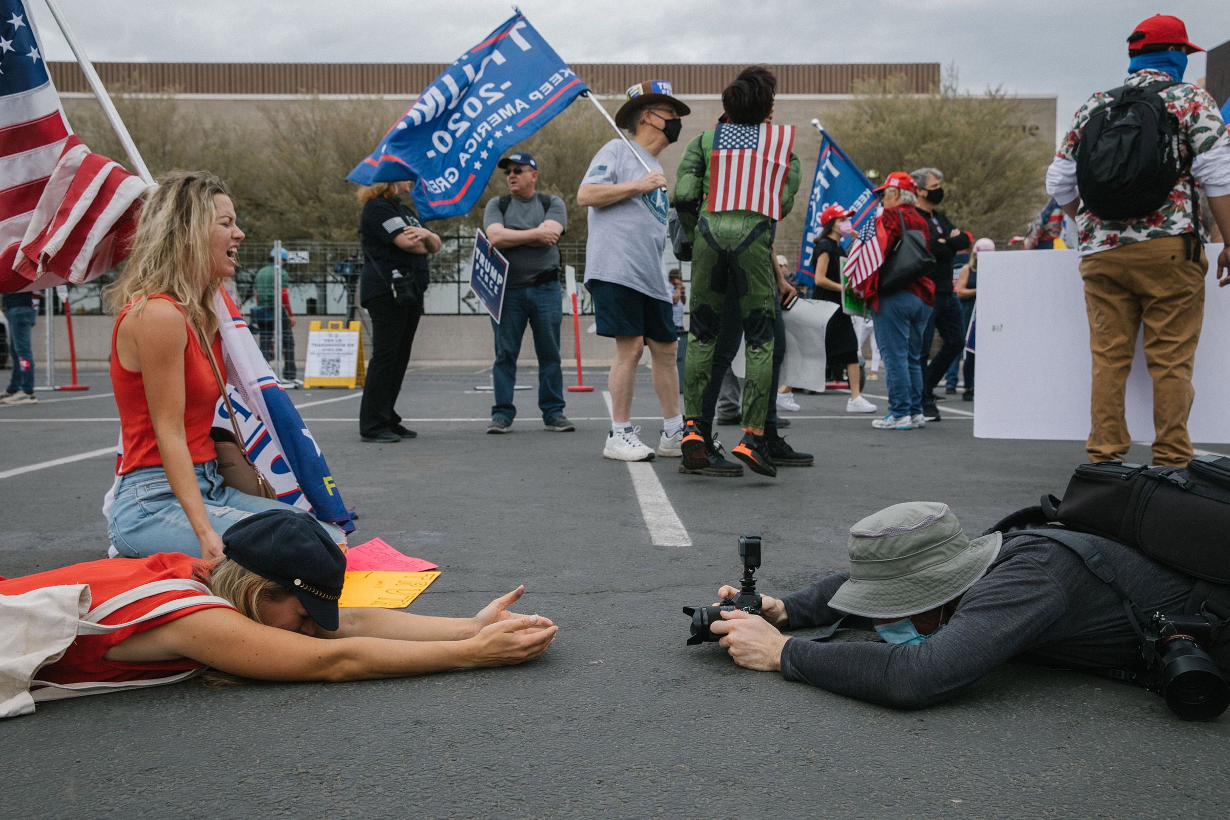 Women pray on the ground at the Maricopa County Elections Department office in Phoenix, AZ on November 6, 2020