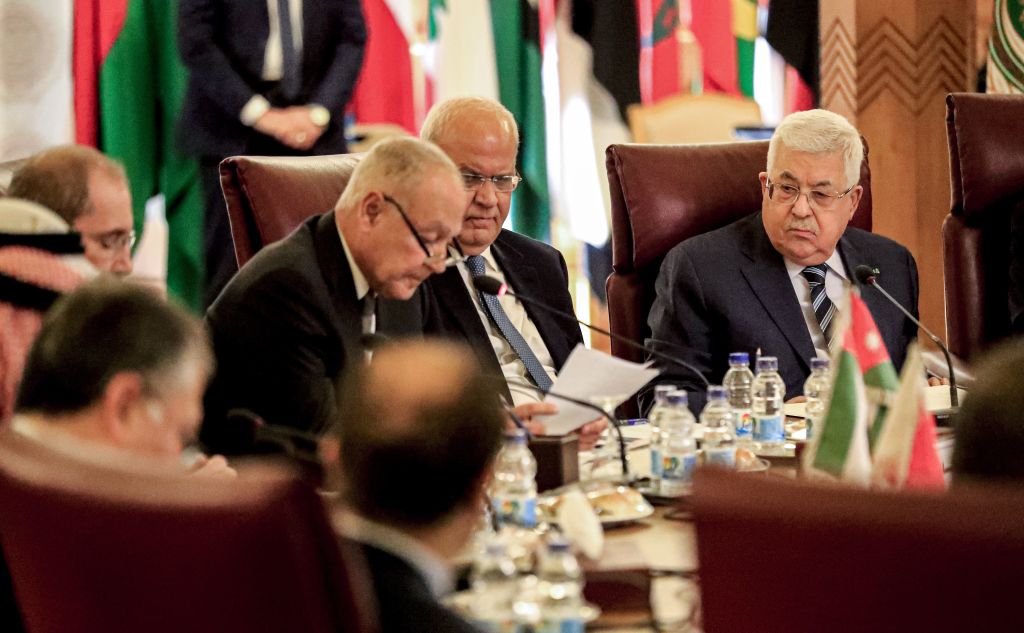 Palestinian president Mahmud Abbas (R) and Palestine Liberation Organisation (PLO) Secretary-General Saeb Erekat (C-R) look on as Arab League Secretary-General Ahmed Aboul Gheit (C) reads a statement during an Arab League emergency meeting discussing the US-brokered proposal for a settlement of the Middle East conflict, at the league headquarters in the Egyptian capital Cairo on February 1, 2020. (Khaled Desouki—AFP via Getty Images)