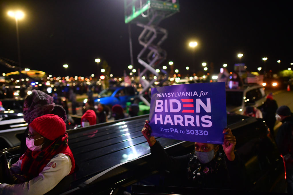 Supporters hold campaign signs as Democratic vice presidential nominee Sen. Kamala Harris speaks at a drive-in election-eve rally on Nov. 2, 2020 in Philadelphia, Pa. (Mark Makela–Getty Images)