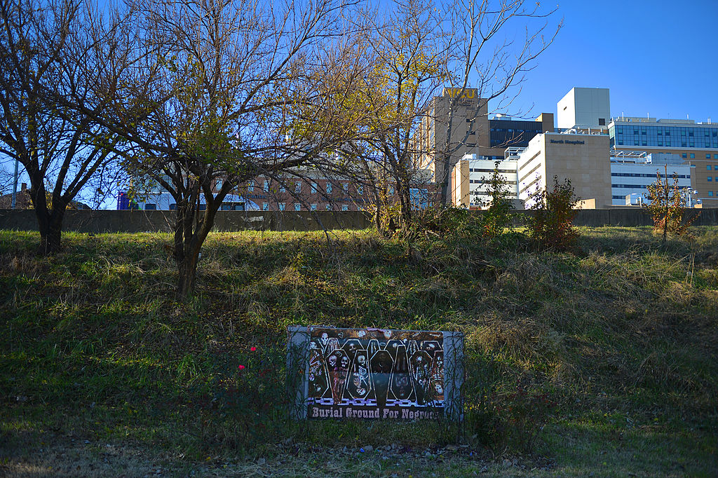 A sign is posted at the site of the African Burial Ground on Nov. 18, 2013, in Richmond, Va. Many of Richmond's enslaved people were buried in graves that now border Interstate 95. (Ricky Carioti—The Washington Post via Getty Images)