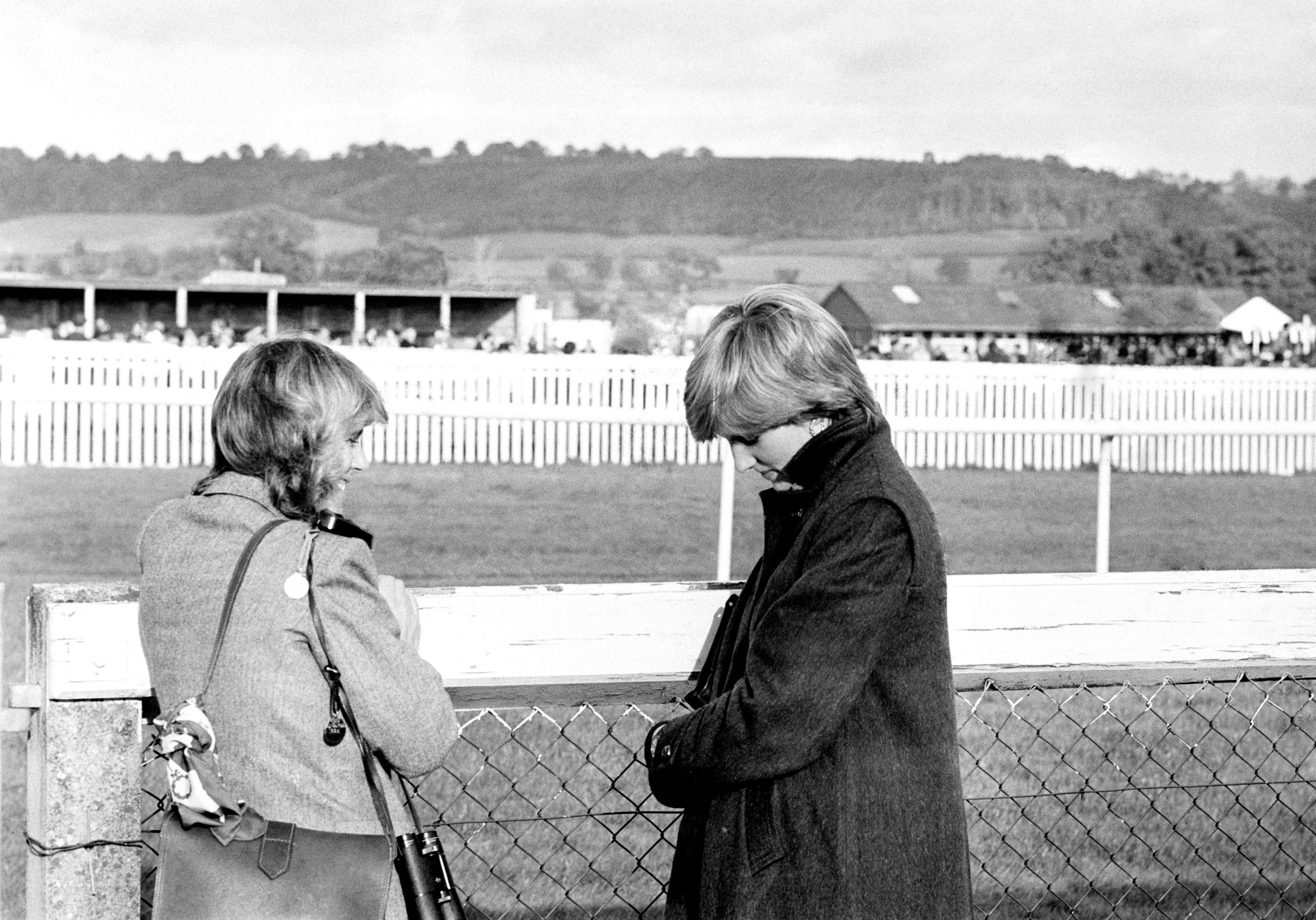 Camilla Parker-Bowles (left) and Lady Diana Spencer (later the Princess of Wales) at Ludlow racecourse to watch the Amateur Riders Handicap Steeplechase in which the Prince was competing (PA Images via Getty Images)