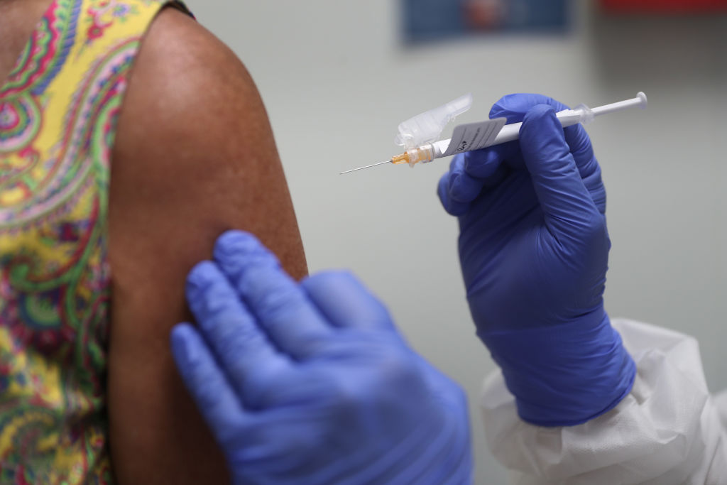 Lisa Taylor receives a COVID-19 vaccination from RN Jose Muniz as she takes part in a vaccine study at Research Centers of America on August 7, 2020 in Hollywood, Florida. (Joe Raedle—Getty Images)