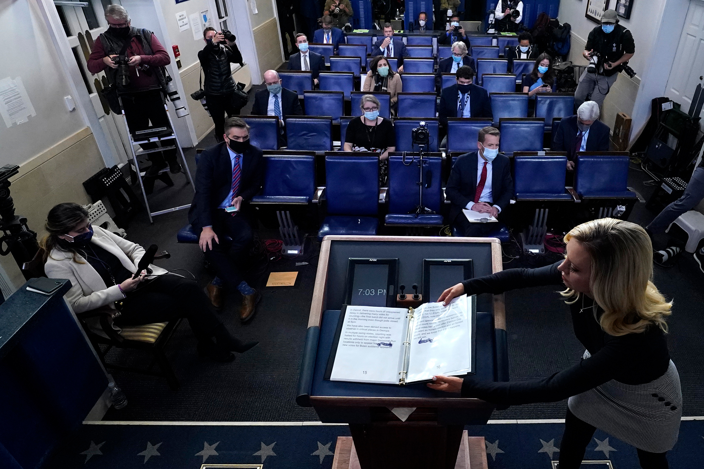 White House Press Secretary Kayleigh McEnany closes a notebook used by President Trump following his remarks on Nov. 5.