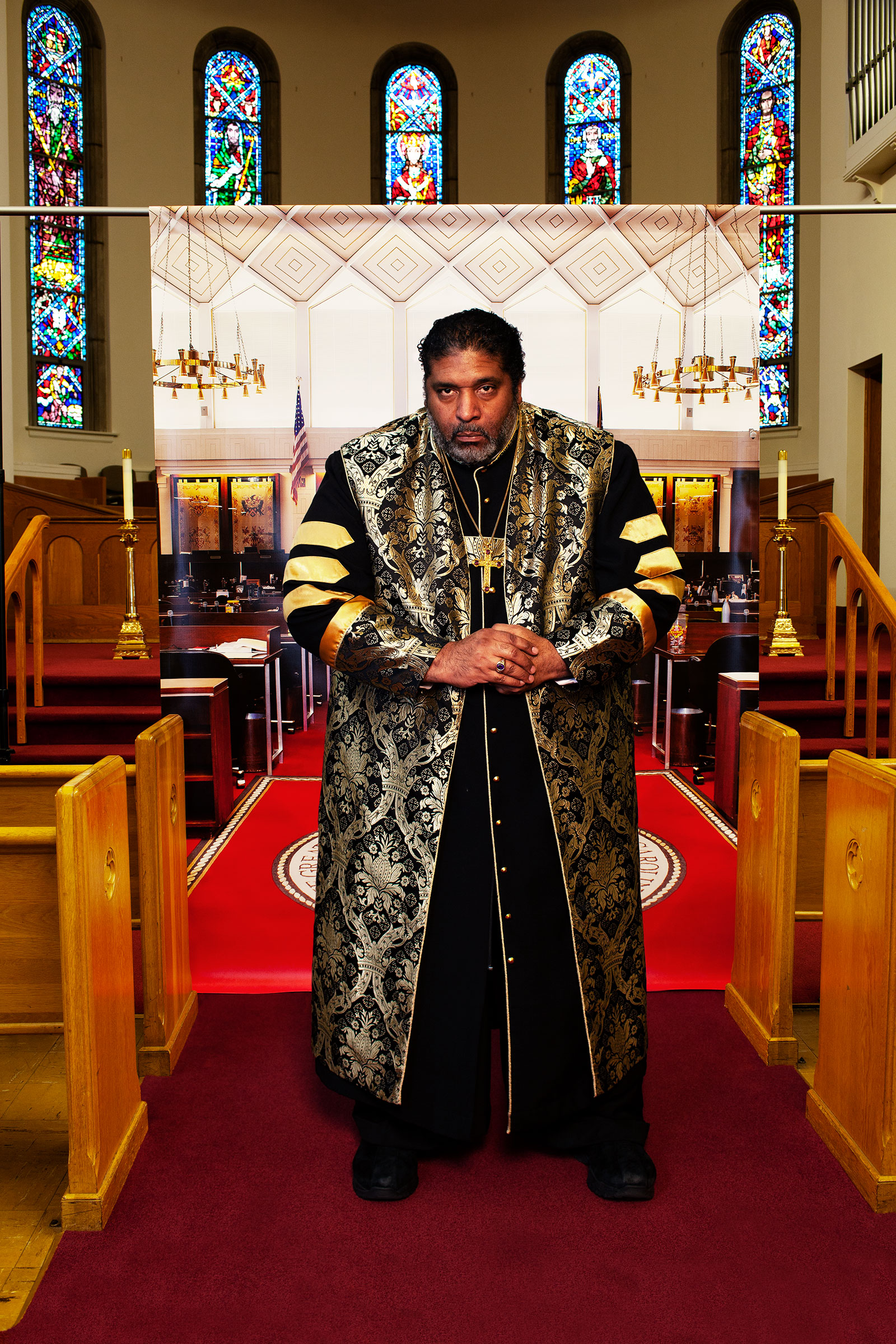 <strong>The Rev. William J. Barber II</strong> at Pullen Memorial Baptist Church in Raleigh, N.C., on Jan. 27, before a backdrop showing the North Carolina house of representatives chamber where he was arrested in 2011. "<a href="https://time.com/5784068/william-barber-ii-faith-injustice/">The Equalizers</a>," March 2 issue. (Endia Beal for TIME)