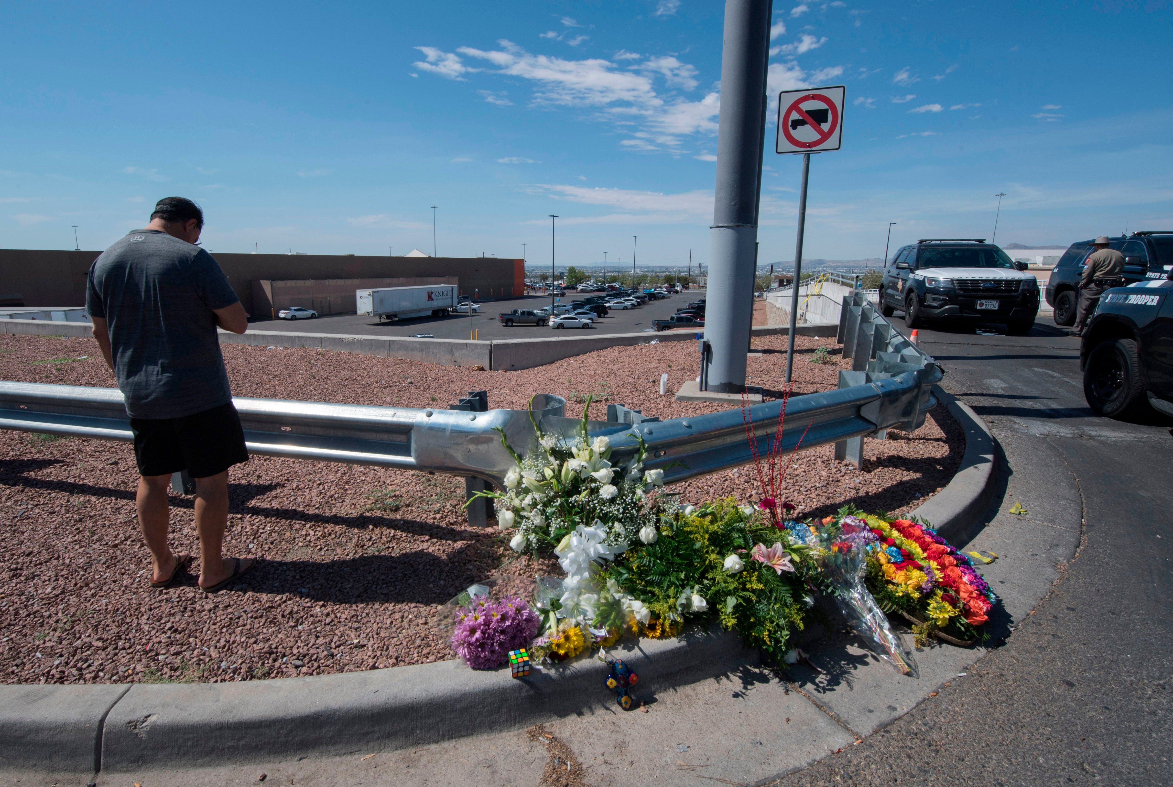 Alfredo Angcana prays beside a makeshift memorial outside the WalMart where a shooting left 23 people dead in El Paso, Texas, on Aug. 4, 2019. (Mark Ralston—AFP/Getty Images)