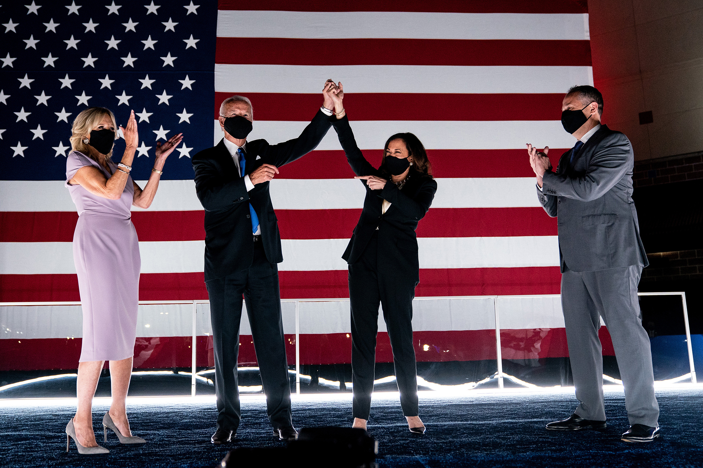 Joe Biden and Sen. Kamala Harris are applauded by their spouses, Jill Biden and Douglas Emhoff, shortly after Biden accepted his party's presidential nomination during the Democratic National Convention in Wilmington, Del., on Aug. 20, 2020.