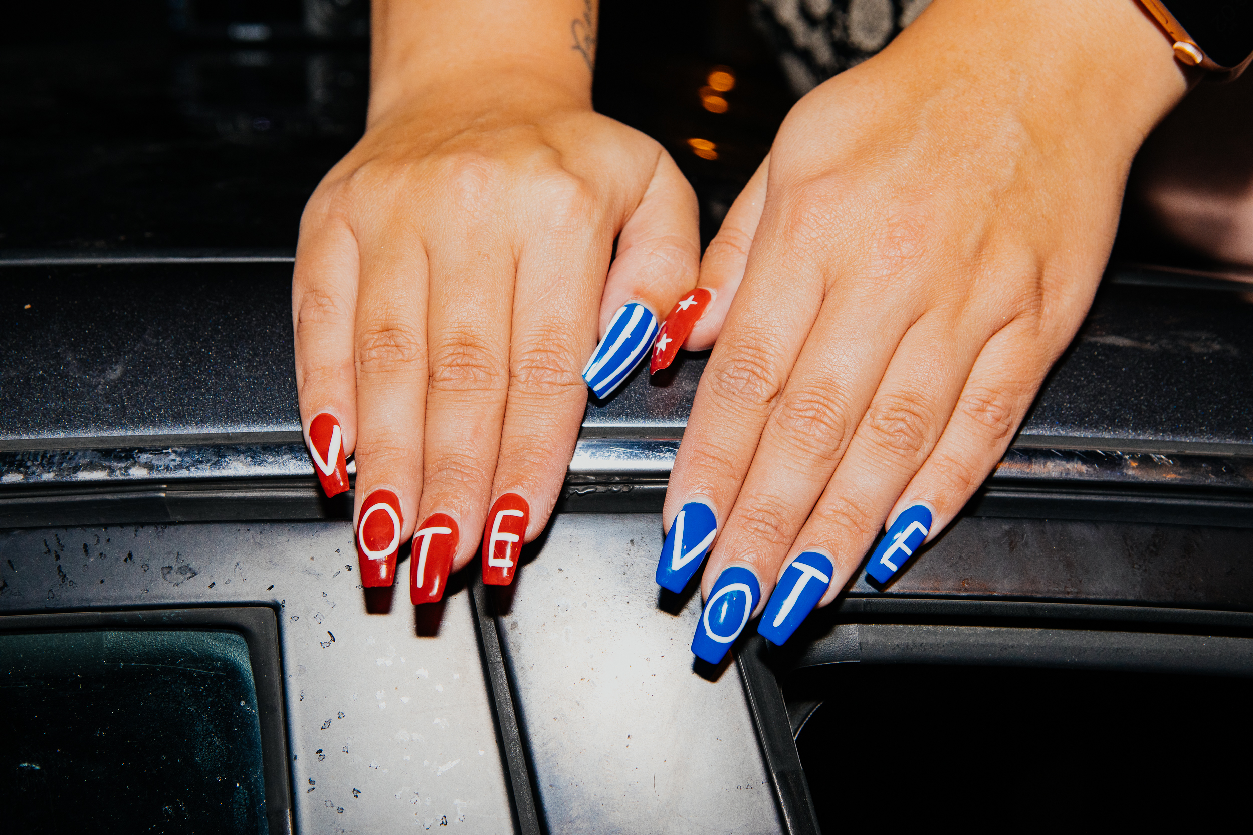 "Vote" nails are seen on Madison Kopie, 25, as she sits on her car outside the Chase Center. (Michelle Gustafson for TIME)