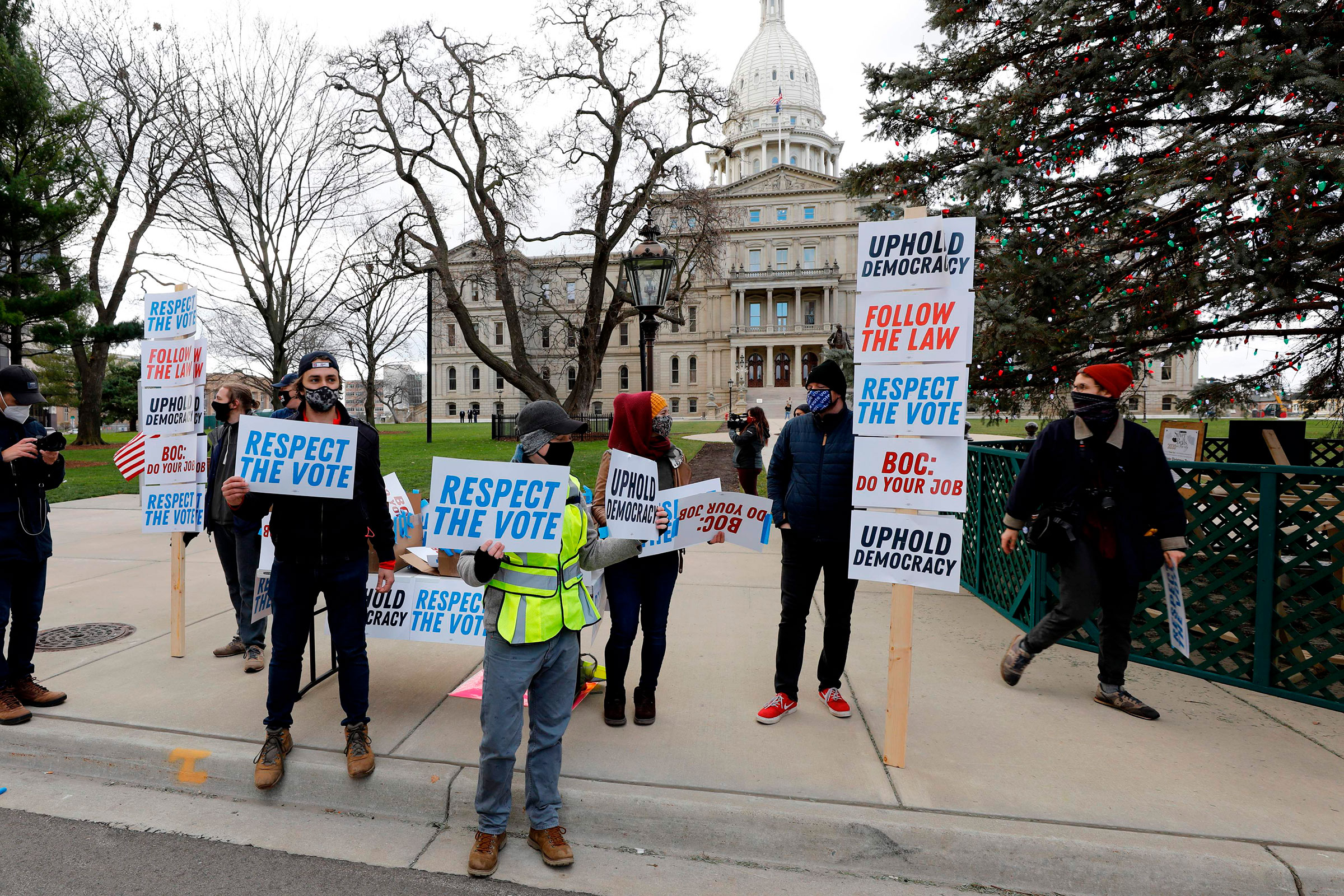 Supporters of President-Elect Joe Biden stand in front of the Michigan State Capital as the Michigan Board of State Canvassers vote today to certify the 2020 election in Lansing, Mich. on Nov. 23, 2020. (Jeff Kowalsky—AFP/Getty Images)