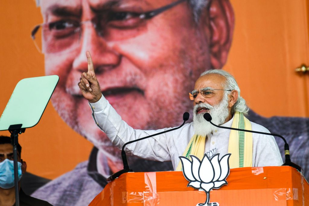 India's Prime Minister Narendra Modi addresses activists and supporters in front of a banner depicting Bihar's chief minister Nitish Kumar during a campaign rally on October 23, 2020. (Sachin Kumar–AFP/Getty Images)