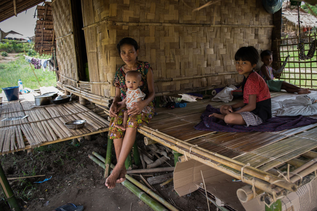 A family displaced by armed conflict between the Myanmar military and the Arakan Army sits at a temporary shelter in Hlegu Township on the outskirts of Yangon on June 25, 2020. (Shwe Paw Mya Tin—NurPhoto/Getty Images)