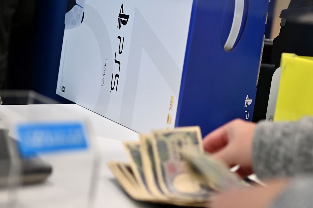 A customer buys the new Sony PlayStation 5 gaming console on the first day of its launch, at an electronics shop in Kawasaki, Kanagawa prefecture on November 12, 2020. (AFP-Getty Images)
