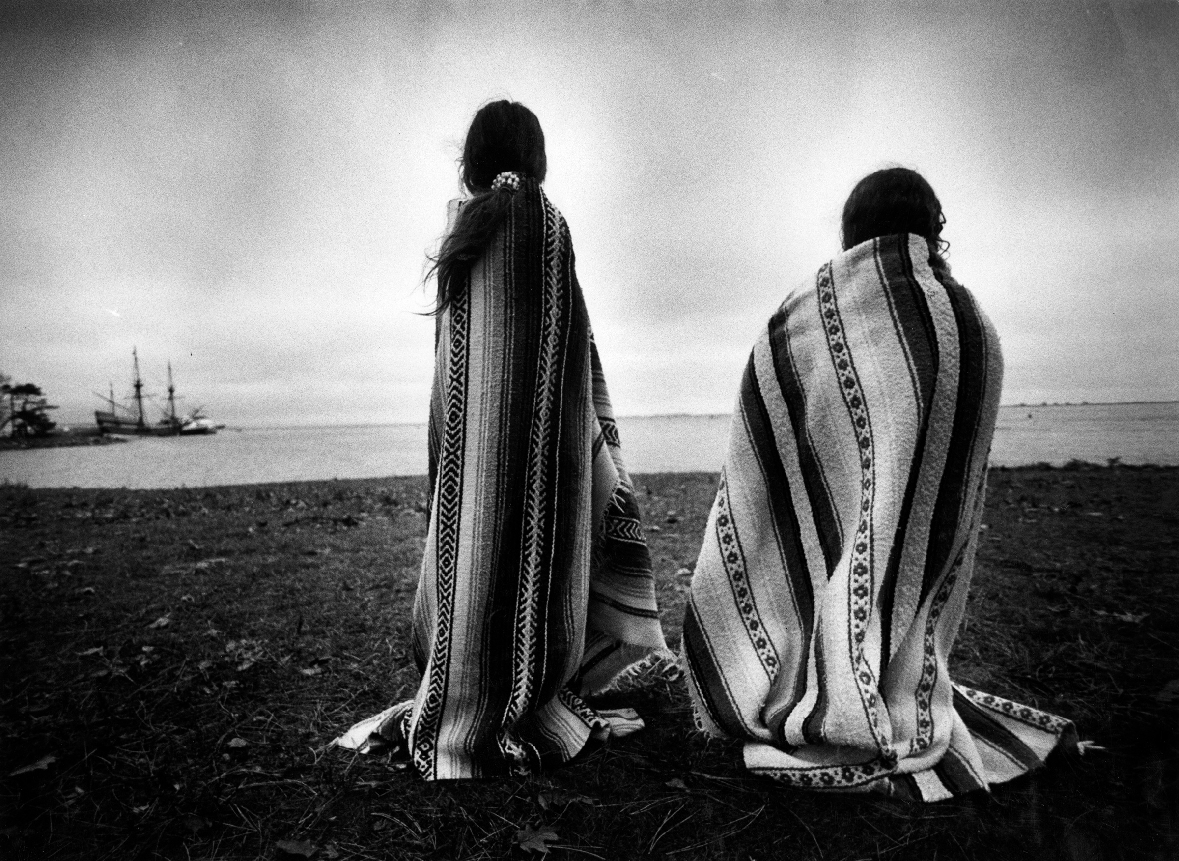 Weetoomoo Carey, 8, left, and Jackolynn Carey, 5, Wampanoag Nipmucs from Mashpee, look across to the Mayflower replica anchored near Plymouth Rock on Nov. 26, 1991. They were with a group of Native Americans gathered for a day of mourning in response to the Pilgrims' Thanksgiving (Suzanne Kreiter—The Boston Globe/Getty Images)