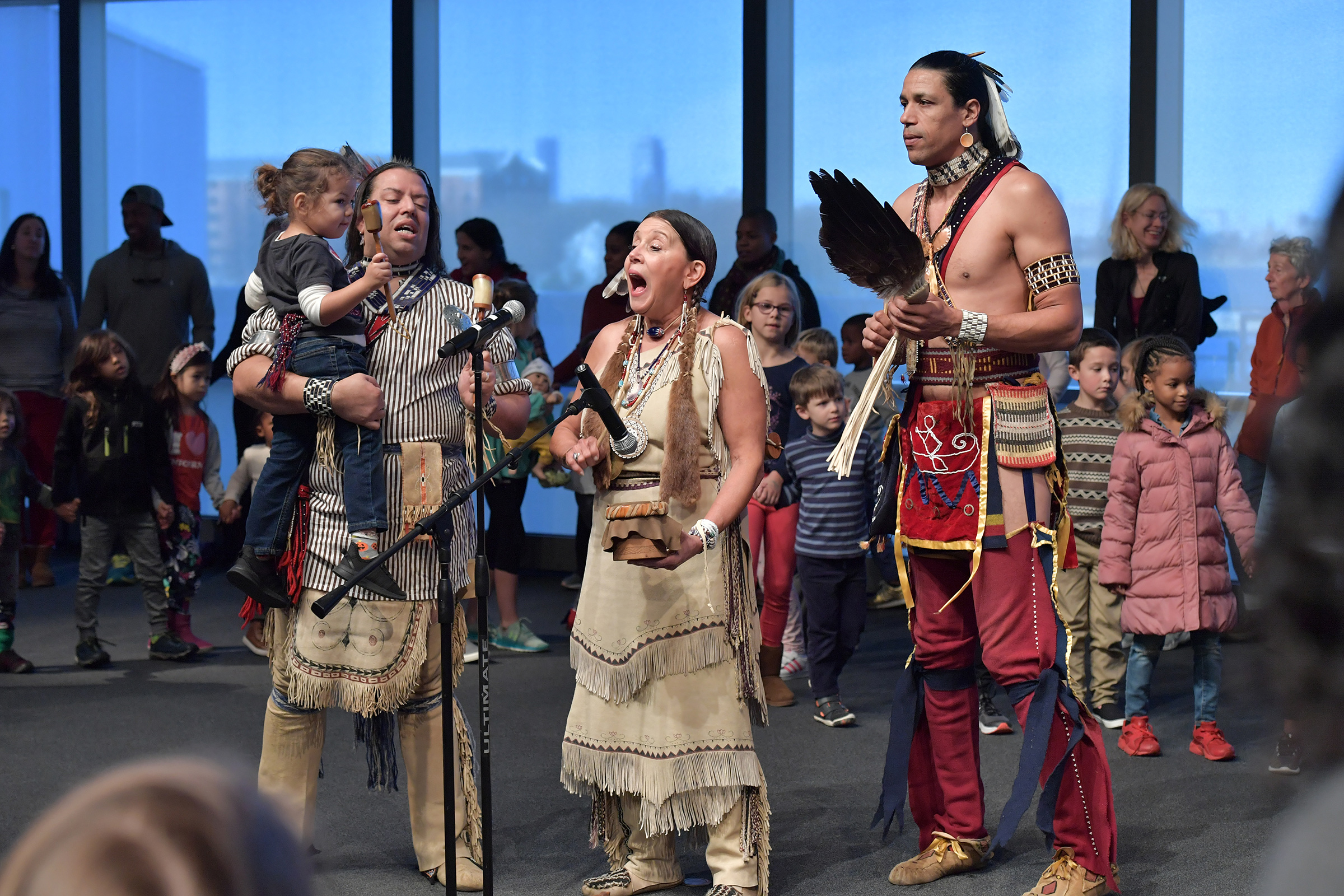 The Wampanoag Nation Singers and Dancers, including Jonathan James-Perry (L) and Kitty Hendricks Miller (C) perform at the John F. Kennedy Presidential Library and Museum on Nov. 29, 2019 in Boston to commemorate Native American Heritage Month