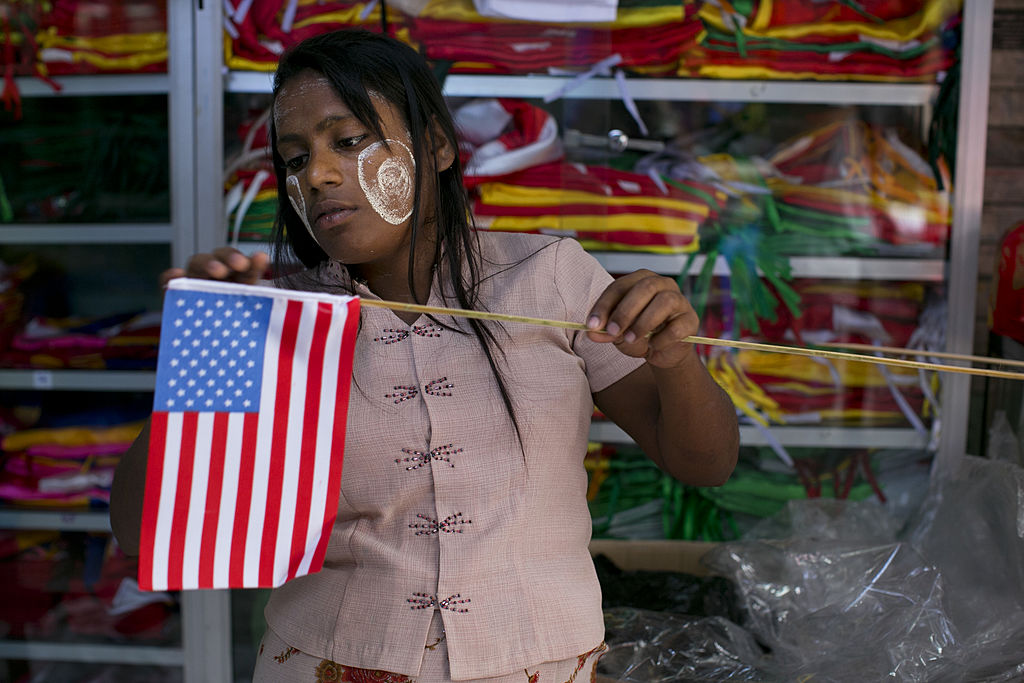 A Myanmar woman fixes an American flag as Yangon prepares for the first visit of President Barack Obama on Nov. 18, 2012. (Paula Bronstein&mdash;Getty Images)