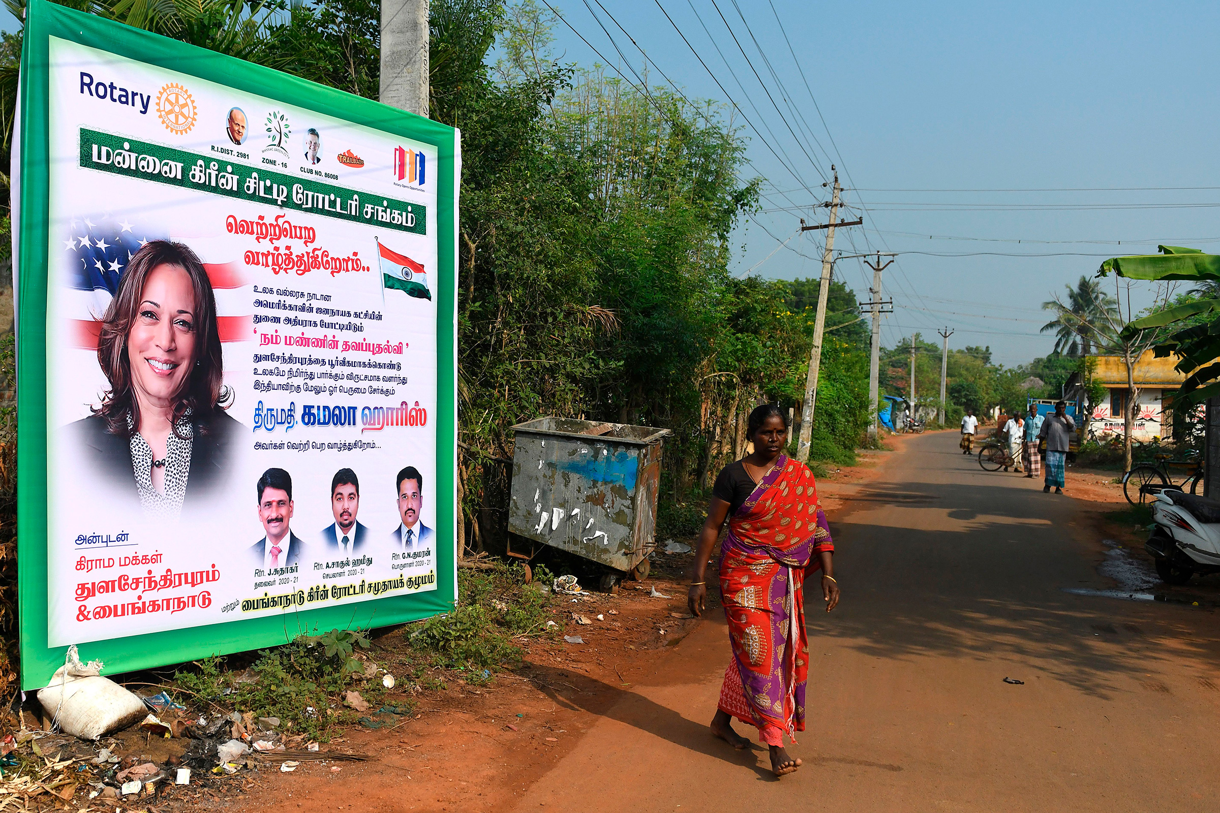A woman walks past a poster of U.S. vice presidential candidate Kamala Harris at her ancestral village of Thulasendrapuram, Tamil Nadu, on Nov. 3. (Arun Sankar—AFP/Getty Images)