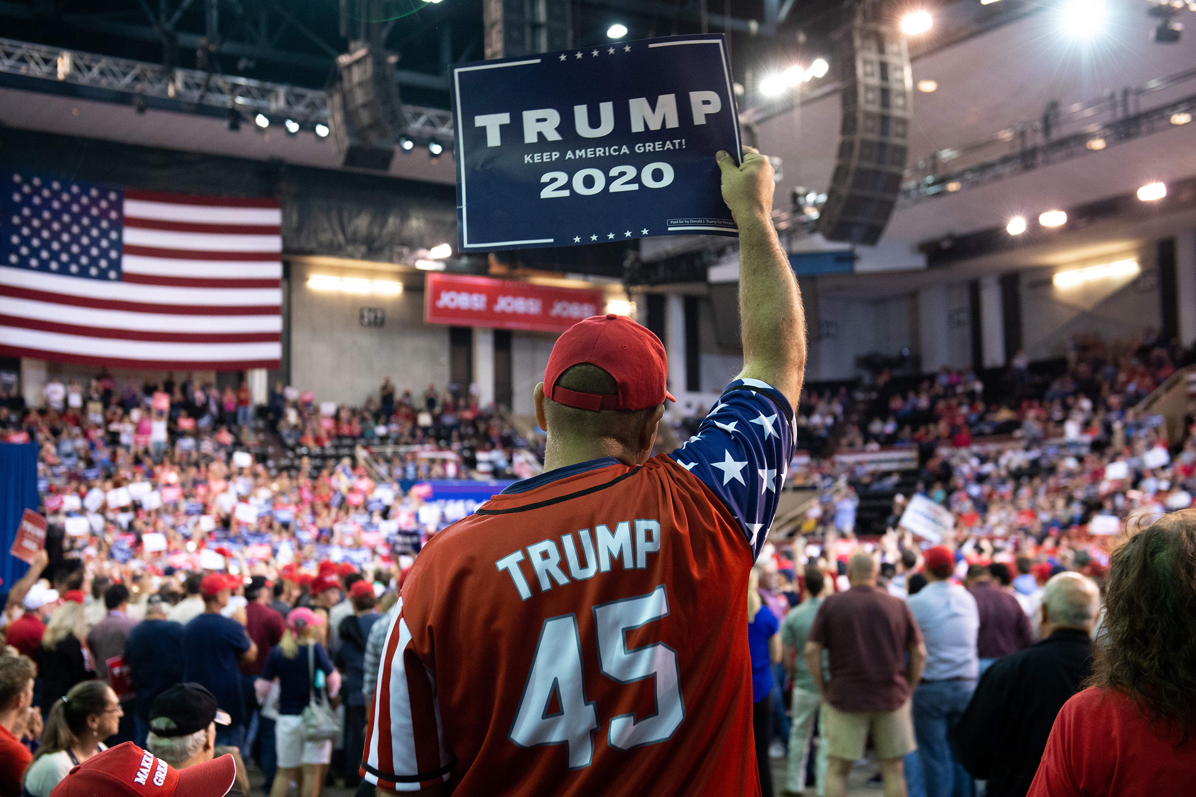 A Trump supporter holds up a sign as the US president speaks during a "Keep America Great" rally at Sudduth Coliseum in Lake Charles, La. on Oct. 11, 2019 (Saul Loeb—AFP/Getty Images)