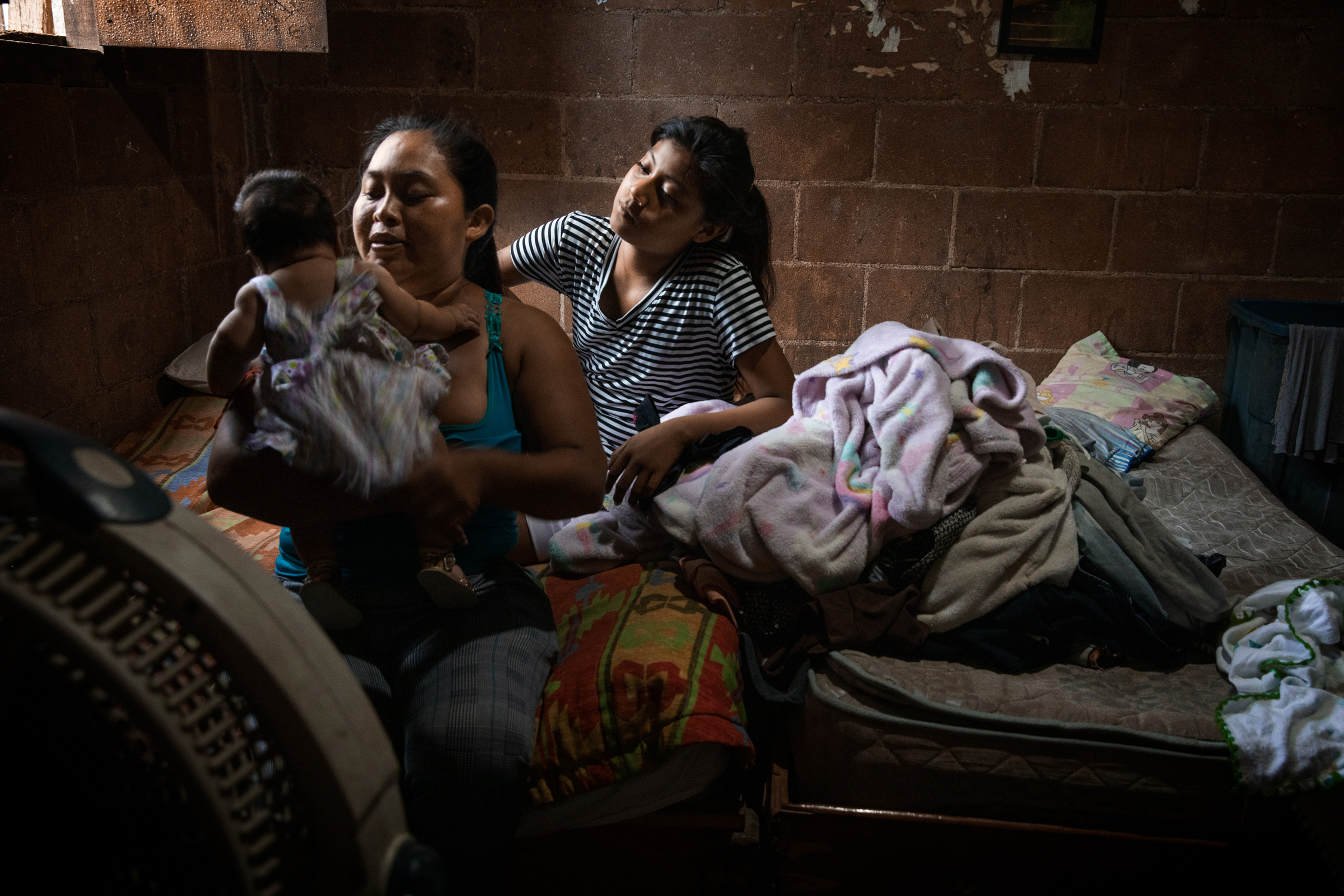 Heidi Hernandez, 29, and her sister Julisa, with Heidi's 2-month-old baby at home, in Tres Reyes, a shanty-town located on the outskirts of Cancún, on Oct. 16. Heidi's baby was due in the middle of the pandemic, but no midwife wanted to help her deliver at home, so Heidi ended up giving birth in the hospital, despite her fear of the virus. (Claudia Guadarrama—Magnum Foundation for TIME)