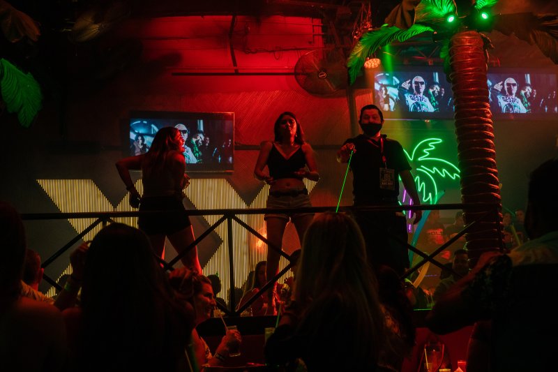 Revelers dance at a club in Cancún’s nightlife district on Oct. 17. Despite the pandemic still raging in Mexico, few tourists wear masks when packed together inside the city’s open-air clubs.
