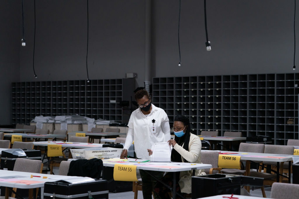 People wearing protective masks hand count 2020 Presidential election ballots during an audit at the Gwinnett County Voter Registration office in Lawrenceville, Georgia, on Nov. 13, 2020. (Elijah Nouvelage—Bloomgberg/Getty Images)