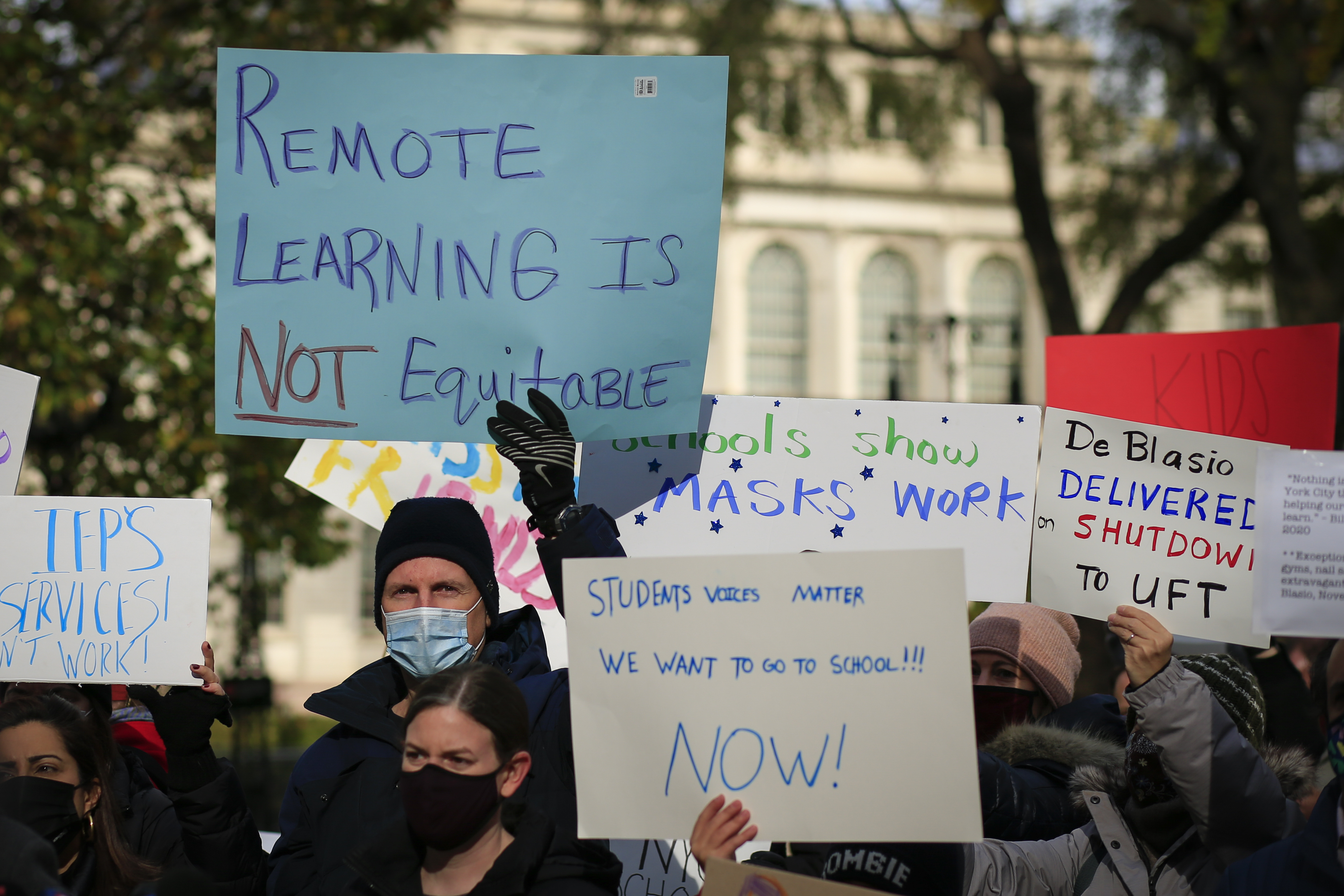 Parents demand a reopening of schools in New York City on Nov. 19 at a protest outside City Hall. The city began allowing some in-person learning to resume on Dec. 7. (Kena Betancur—AFP/Getty Images)