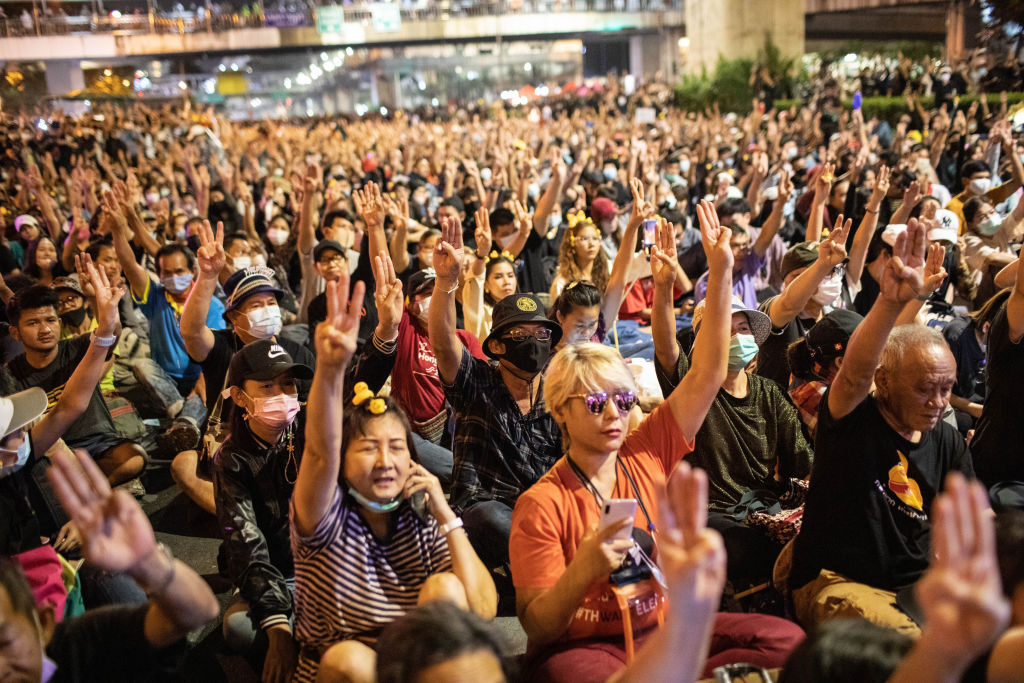 Pro-democracy protesters give the three finger salute during an anti-government demonstration in Bangkok, Thailand on November 27, 2020. (Stringer/Anadolu Agency via Getty Images)