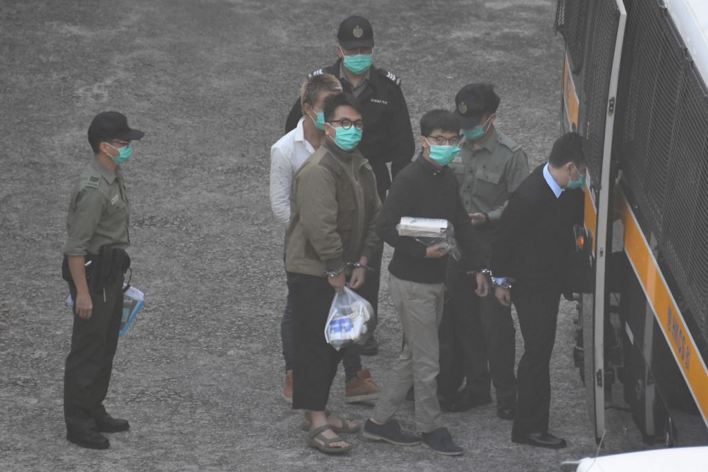 (L) Ivan Lam (R) Joshua Wong seen entering a prison van at Lai Chi Kok Reception Centre on December 2, 2020 in Hong Kong, China. (Vernon Yuen/NurPhoto via Getty Images)