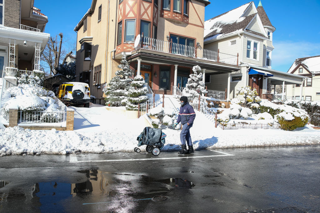 A USPS worker delivers mail in Weehawken, New Jersey on Dec. 17 (Tayfun Coskun—Anadolu Agency/Getty Images)