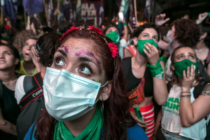 Pro-choice protesters wait outside the National Congress as senators decide on the legalization of abortion on Dec. 30, 2020 in Buenos Aires, Argentina