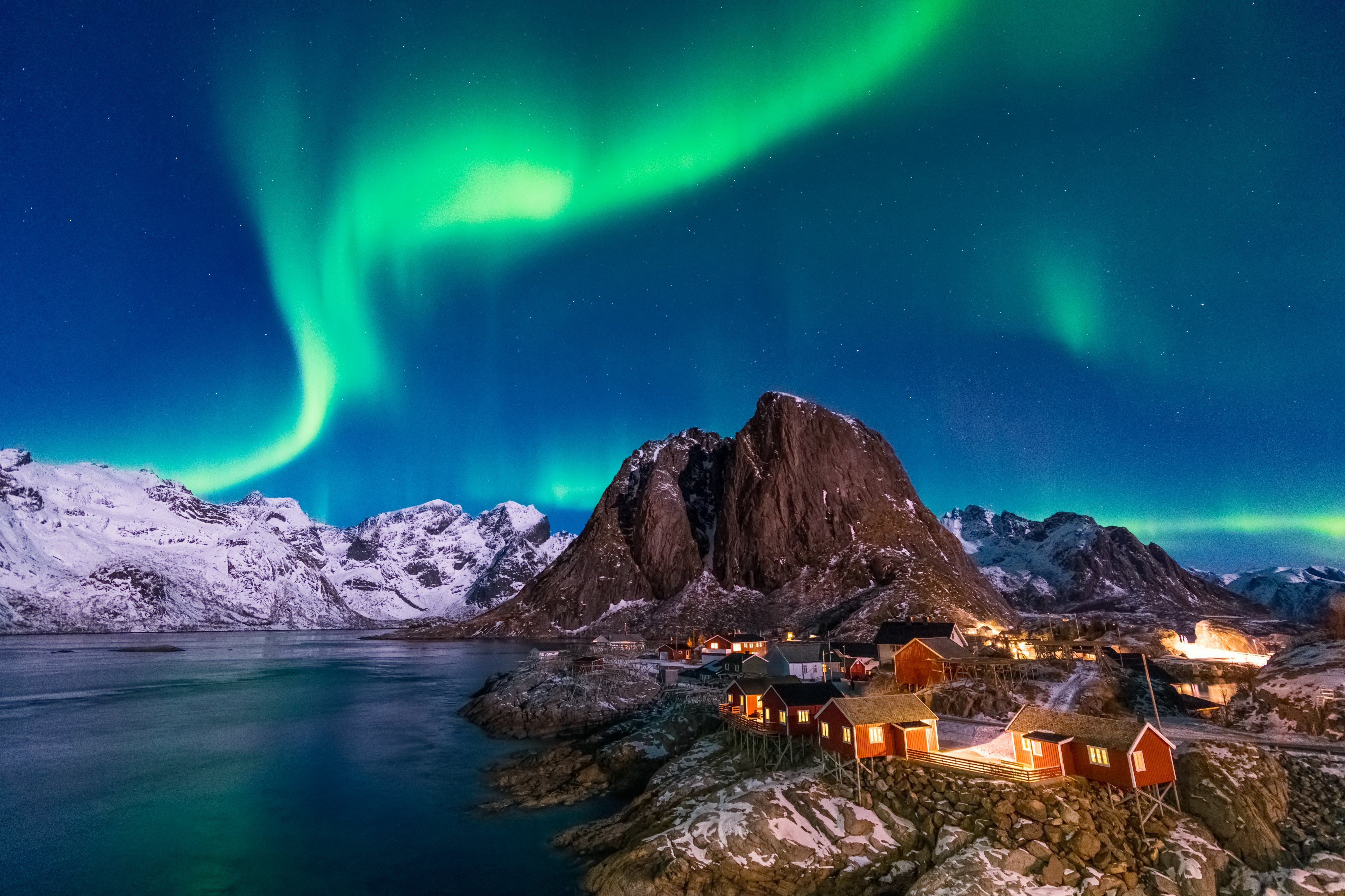 Northern Lights (Aurora Borealis) above the iconic view of a picturesque fishing village in Hamnoy (Hamnøy), Lofoten islands, Norway in winter. (Getty Images/Noppawat Charoensinphon)