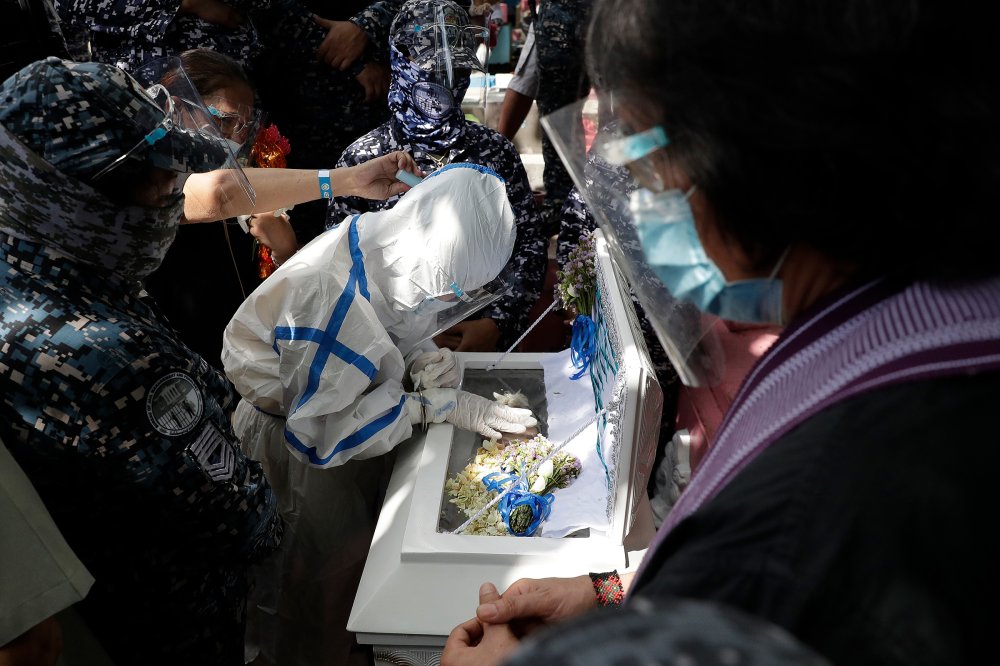 Detained left-wing activist Reina Mae Nasino, in handcuffs and wearing a protective suit to prevent the spread of coronavirus, touches the coffin of her three-month-old daughter, River, during funeral rites guarded by armed escorts at Manila North Cemetery on Oct. 16. The 23-year-old was among three activists arrested last year in a Philippine left-wing group’s office, the Associated Press reported, and charged with the illegal possession of explosives and firearms; their lawyers alleged that the weapons were placed by police, which denied the accusation. A court allowed Nasino three hours to attend the burial of her baby, who died of acute gastroenteritis, the AP added, but critics decried her treatment.
