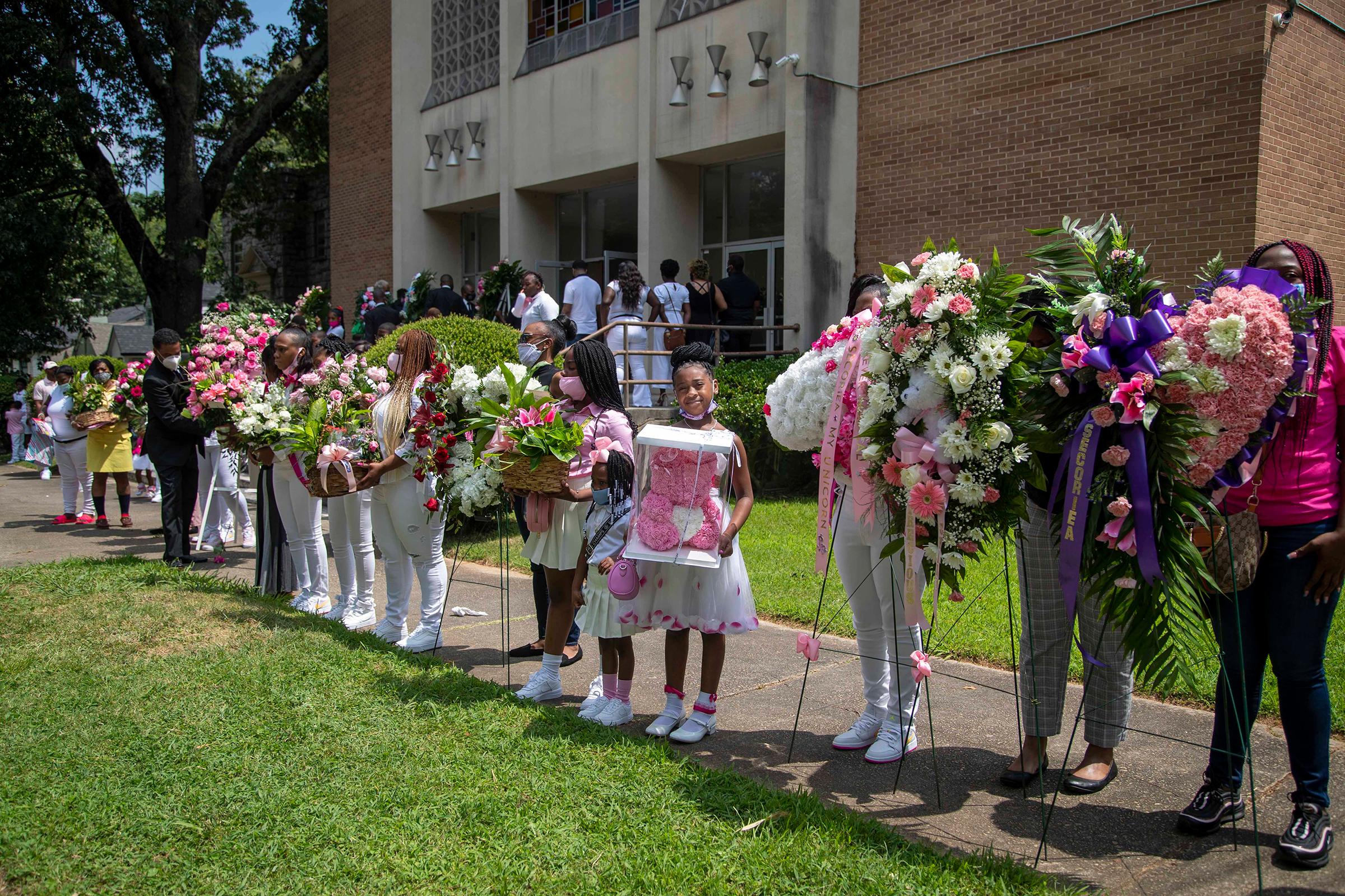 Family and friends of Secoriea Turneran eight-year-old who was fatally shot while in a car with her mother near the site where Rayshard Brooks was killed by a police officer weeks earlier, leading to protests against police brutality, present floral arrangements during her home-going service at New Calvary Missionary Baptist Church in Atlanta on July 15, 2020.