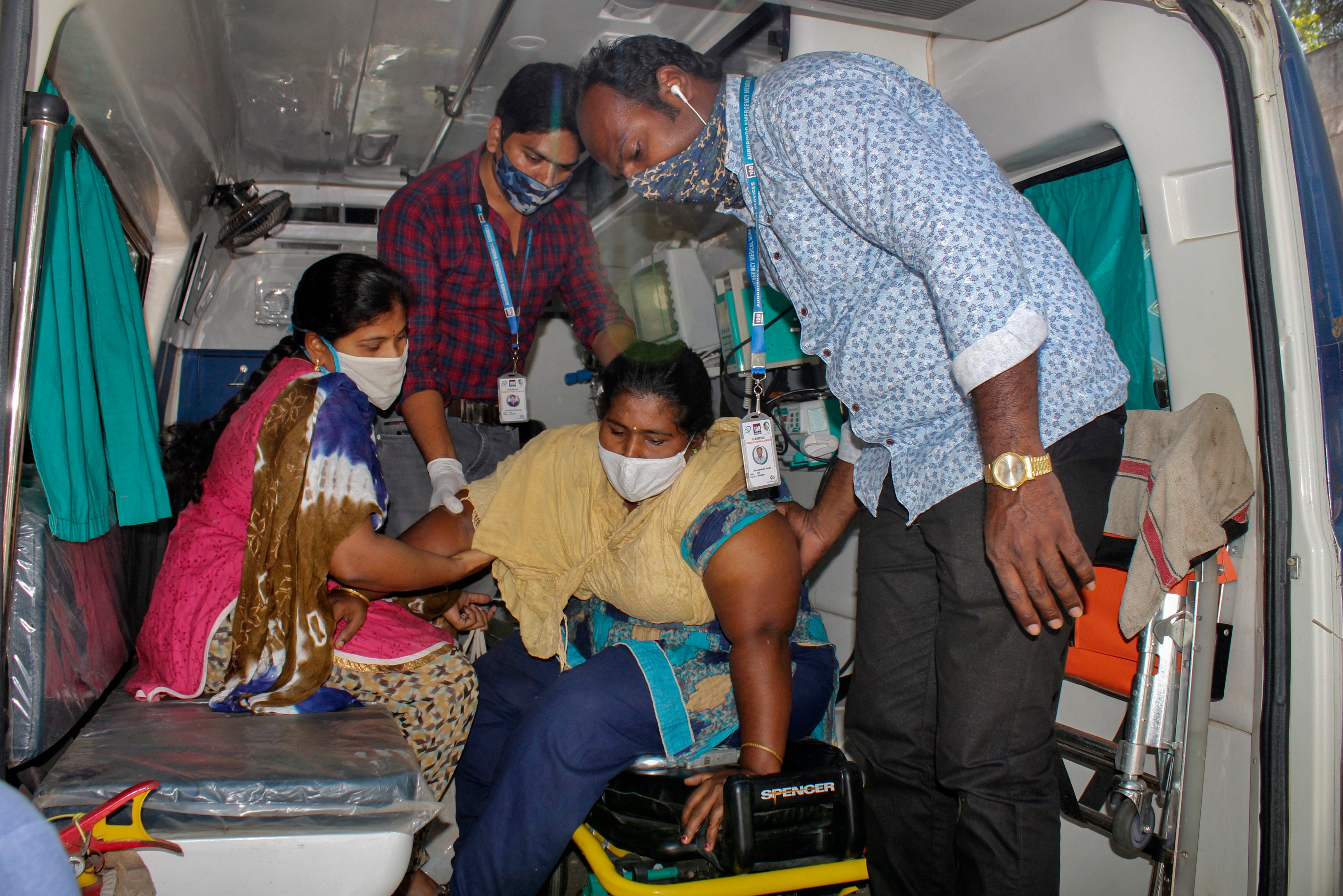 A patient is assisted by others to get down from an ambulance at the district government hospital in Eluru, Andhra Pradesh state, India, Tuesday, Dec. 8, 2020. Health officials and experts are still baffled by a mysterious illness that has left over 500 people hospitalized and one person dead in this southern Indian state. (AP)