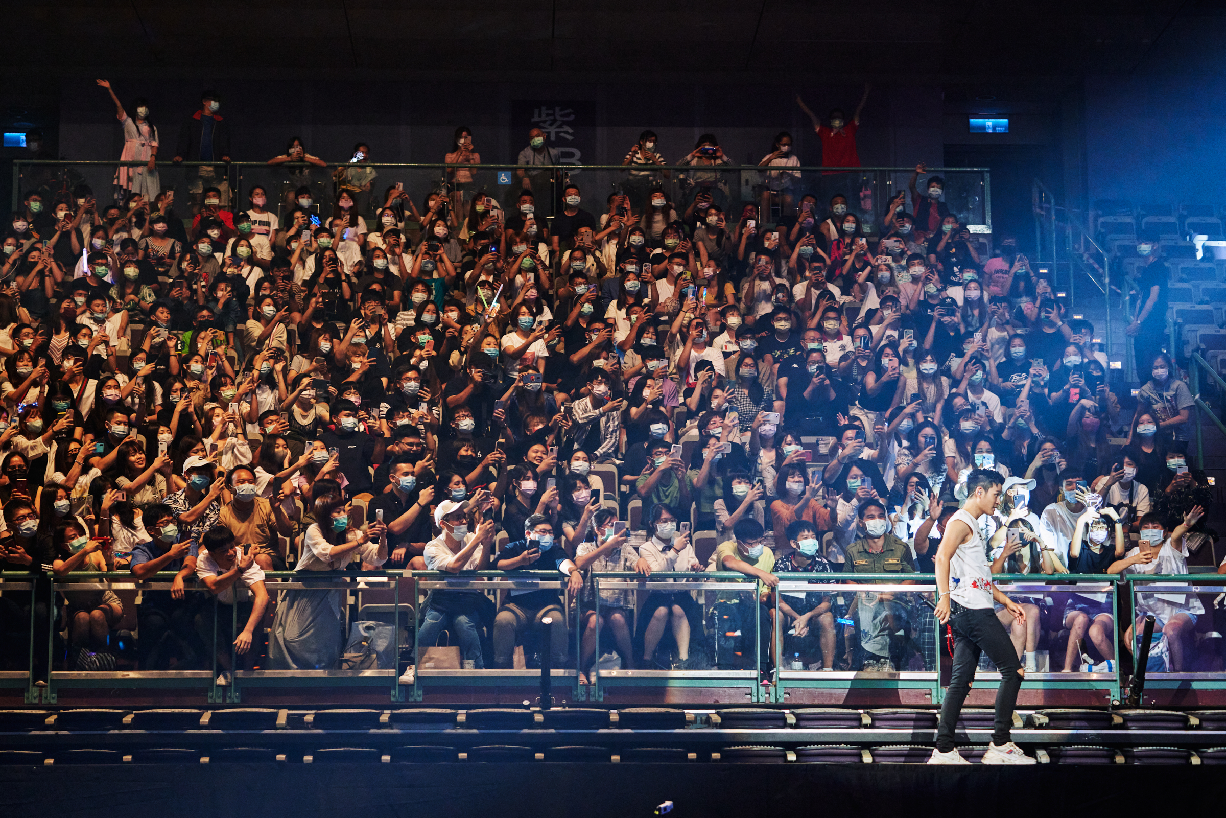 <a href="https://time.com/5880129/concerts-coronavirus-taiwan/" target="_blank" rel="noopener noreferrer">Eric Chou</a> walks on an extended stage that brought him close to fans sitting on the second level of the Taipei Arena on Aug. 8. (An Rong Xu for TIME)