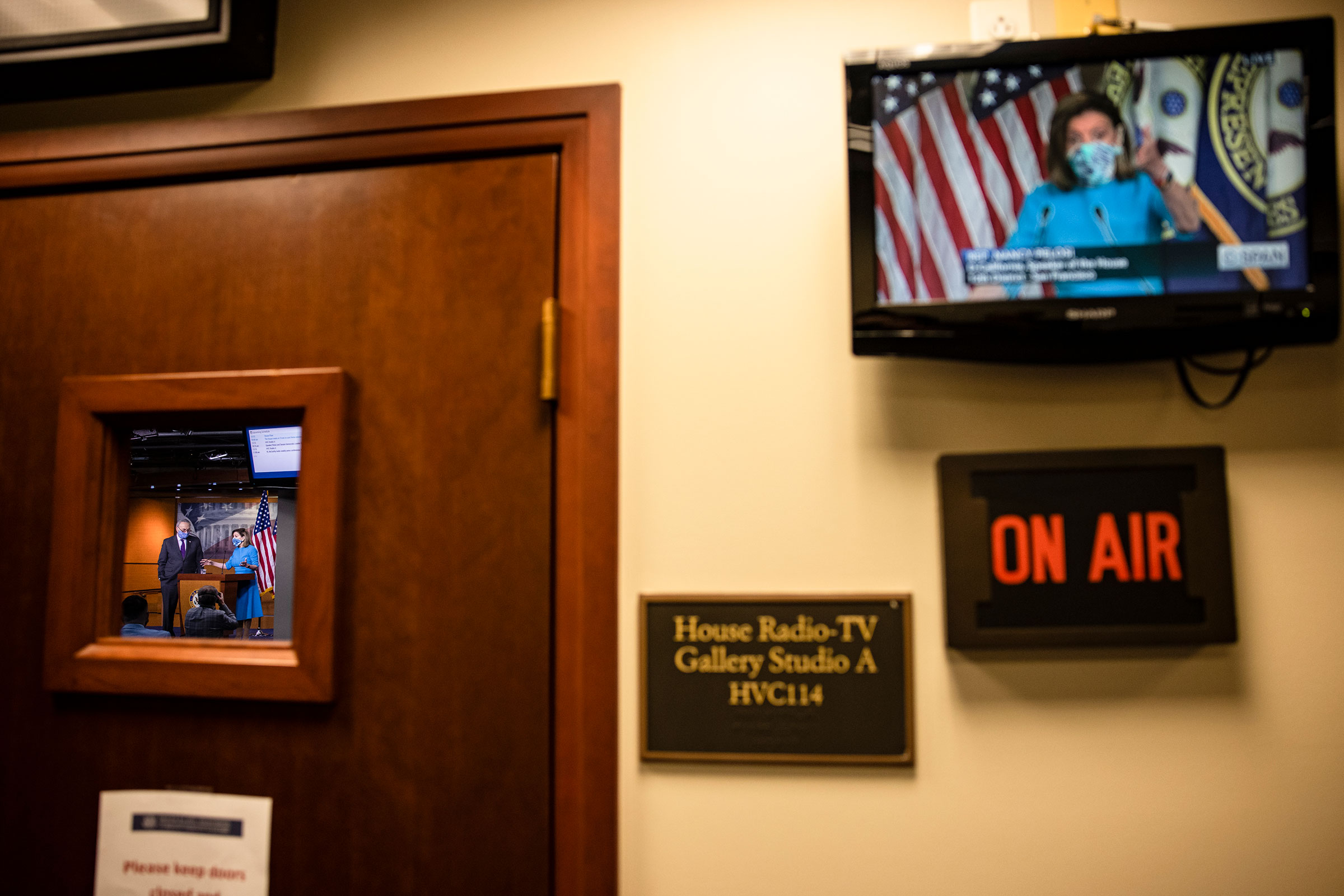 The broadcast of the press conference with Speaker of the House Nancy Pelosi and Senate Minority Leader Chuck Schumer is seen on a television outside of where it is being held at the U.S. Capitol on Nov. 12, 2020. (Samuel Corum—Getty Images)