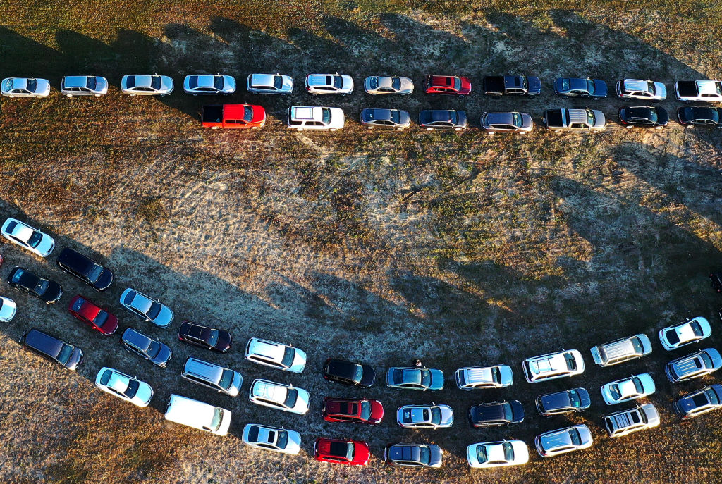In this aerial view from a drone, people line up in their cars to receive food assistance at the Share Your Christmas food distribution event sponsored by the Second Harvest Food Bank of Central Florida, Faith Neighborhood Center and WESH 2 at Hope International Church in Groveland, Fla., on Dec. 9, 2020. (Paul Hennessy—NurPhoto/Getty Images)