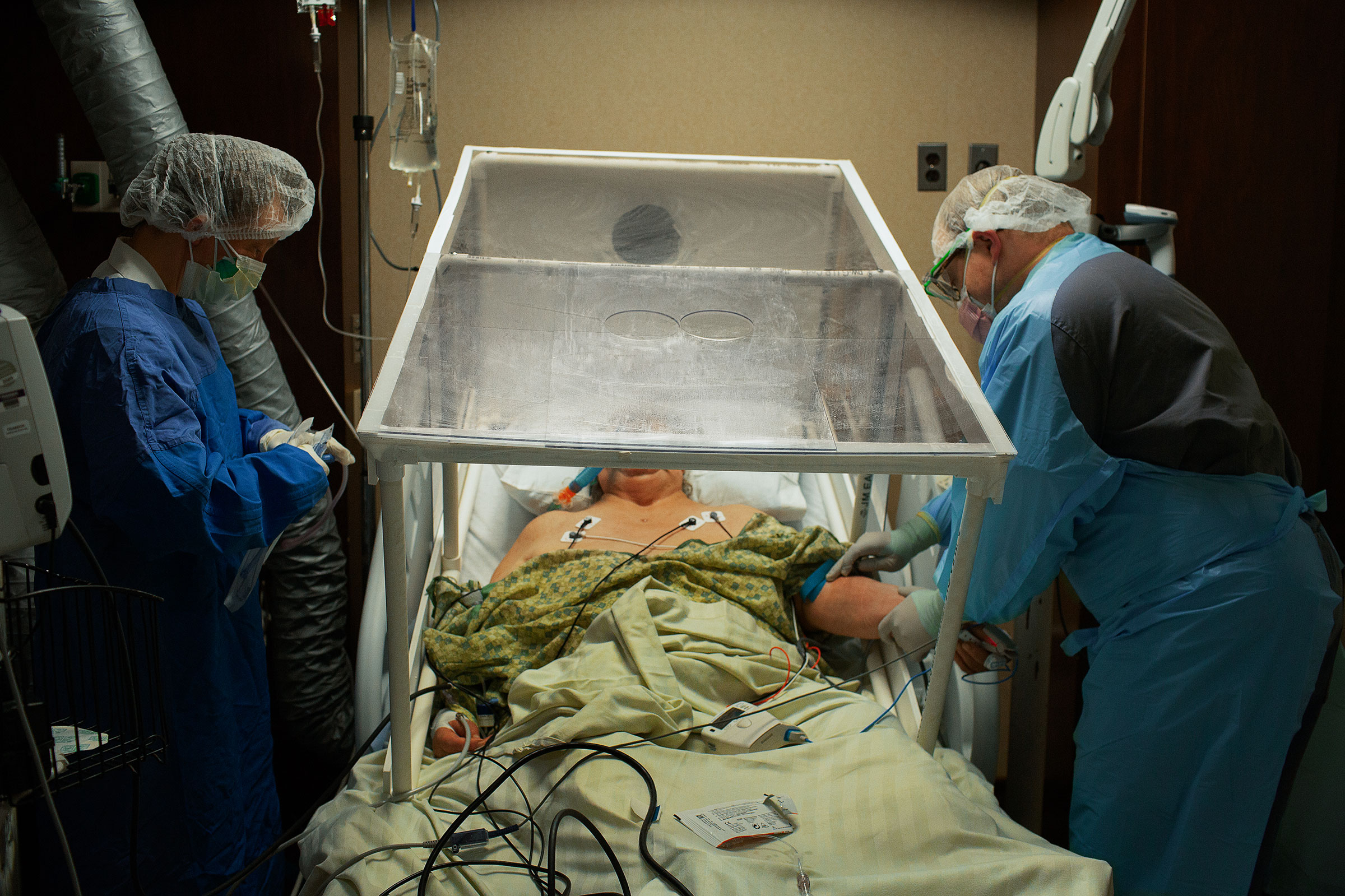 A COVID-19 patient is prepared for intubation by the anesthesiologist at Holy Name Medical Center in Teaneck, N.J., on March 31. The plastic tent is so the virus isn’t spread while transporting the patient between units. (Danny Kim for TIME)
