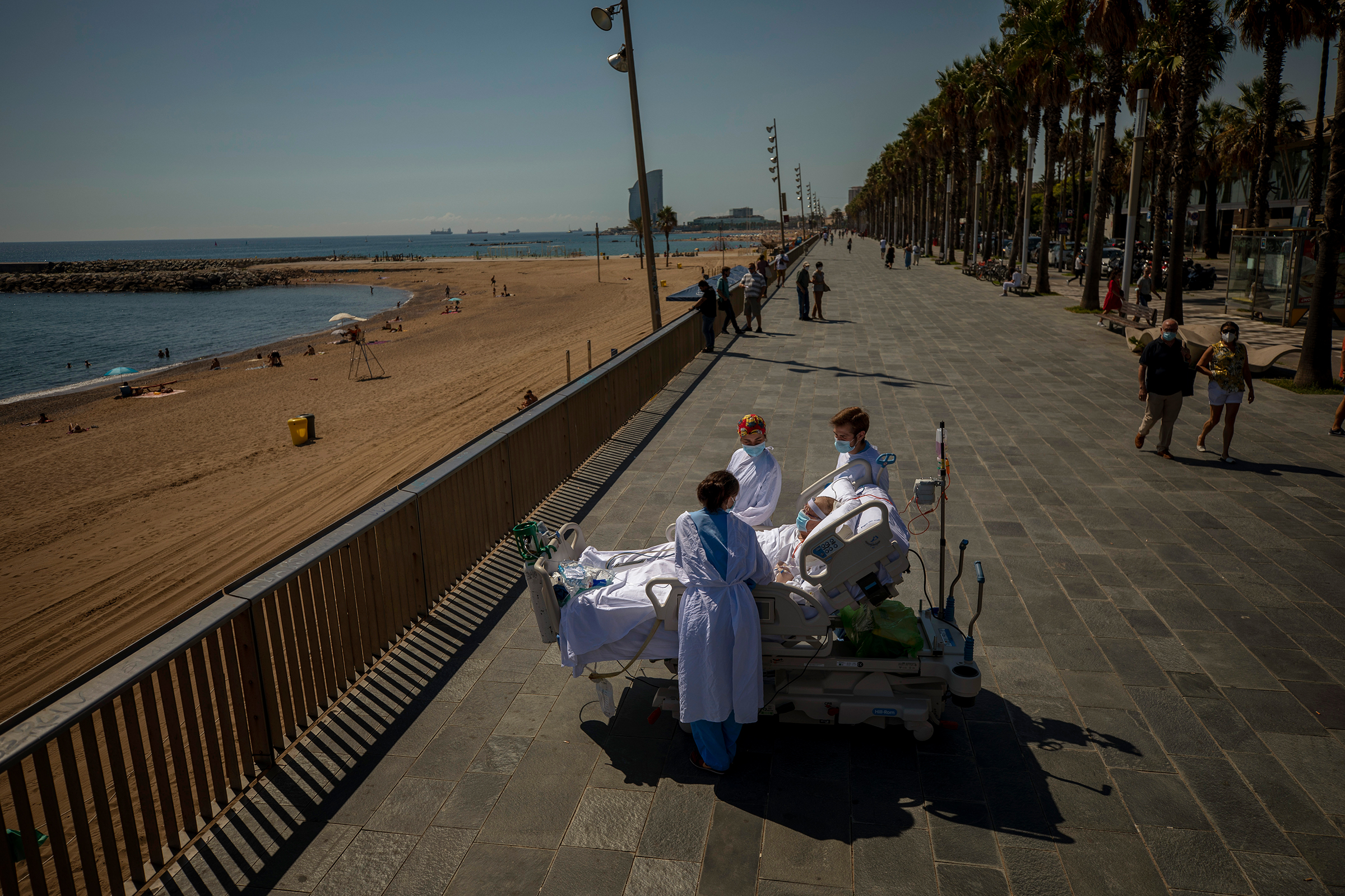 Francisco Espana, 60, is surrounded by members of his medical team on a promenade next to the Hospital del Mar in Barcelona on Sept. 4. (Emilio Morenatti—AP)