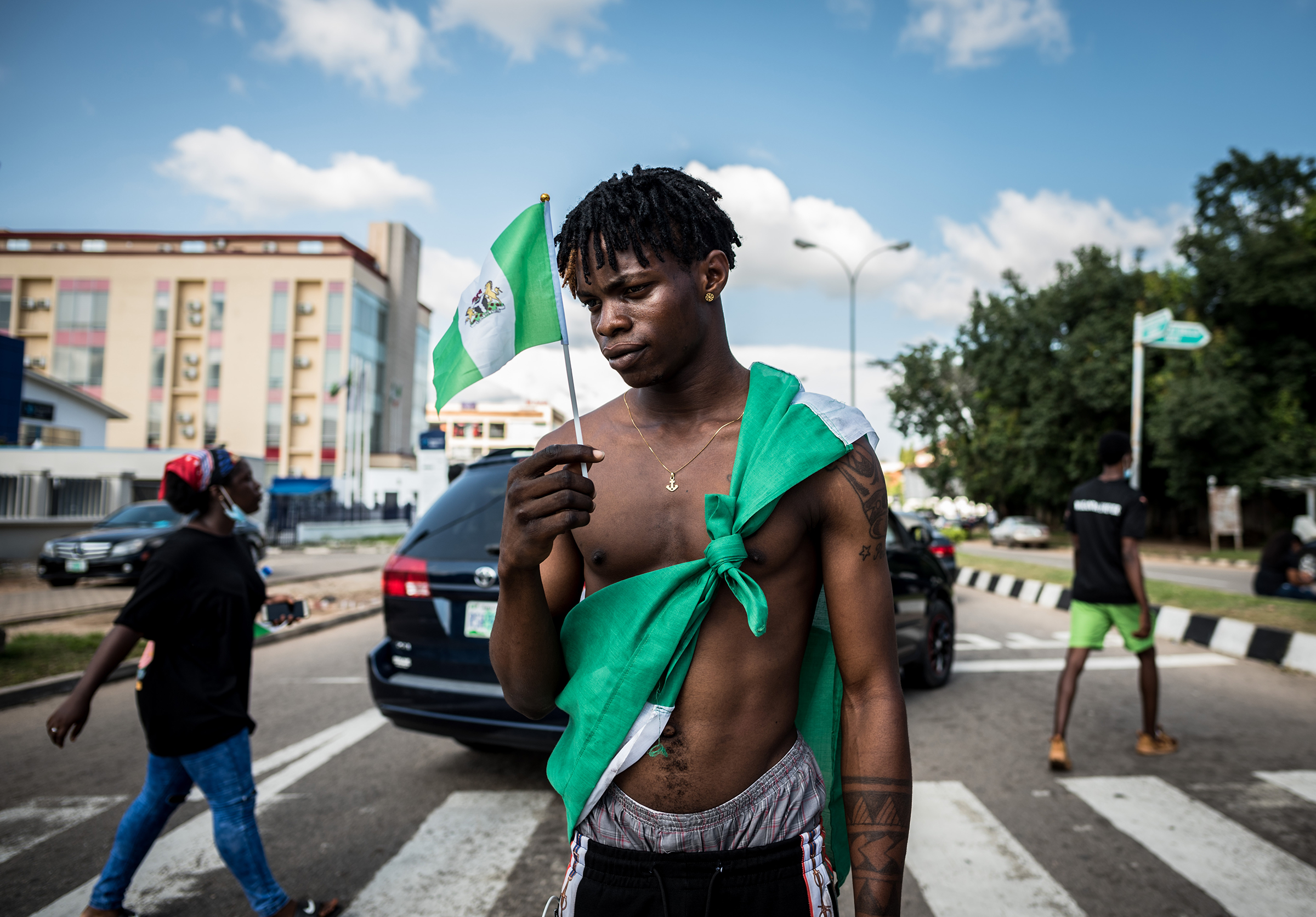 A protester holds a Nigerian flag at an #EndSars demonstration in Abuja on Oct. 17. "The atmosphere during the protests were highly liberating and gave me hope," the photographer recalls. "I had never imagined that Nigerians will be able to see past religion, ethnicity and social class and come together to march for a common cause."