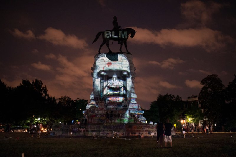 The image of George Floyd along with the Black Lives Matter letters are projected onto the Robert E. Lee Statue on Monument Avenue in Richmond, Virginia, on June 10, 2020.